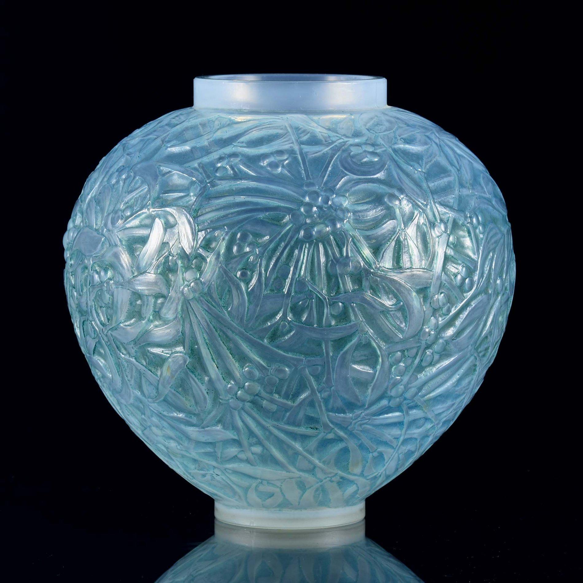 An attractive early 20th century French opalescent glass vase decorated with fruiting mistletoe around the circumference of the vase, with deep sky blue color highlighted with turquoise staining and fine detail, signed R Lalique

Vase