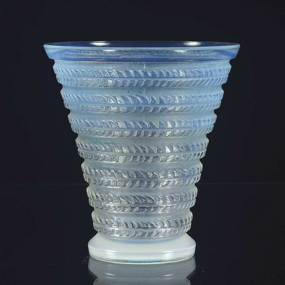 Very pretty small decorative Art Deco vase in frosted, burnished and opalescent glass of conical form with spreading circular foot, the body of the vase decorated with raised geometric design, signed to base, signed to base R