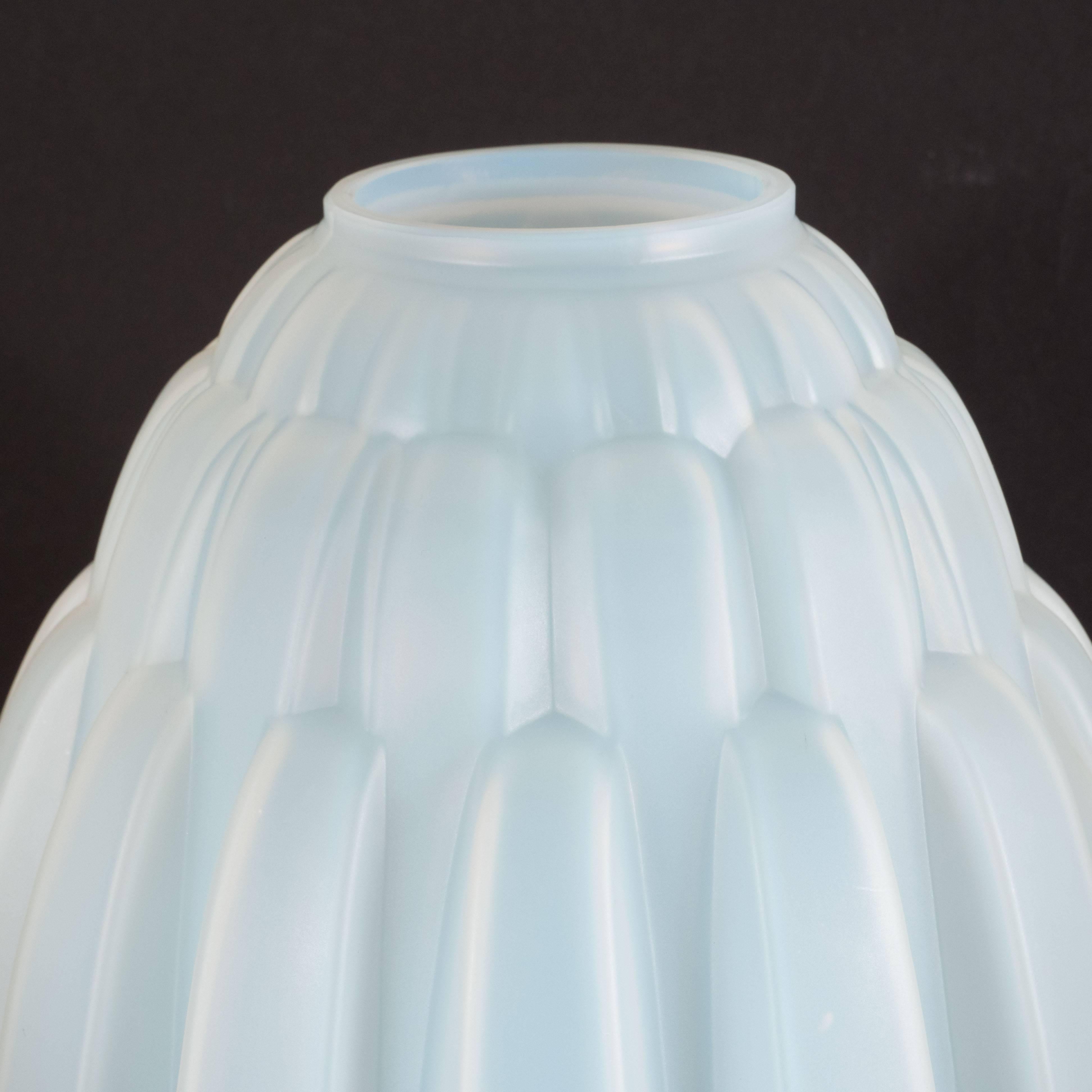 This gorgeous skyscraper style vase was hand blown by Andre Hunebelle- one of the most esteemed glass ateliers of the period- in France, circa 1930. It features a conical body inscribed with abundance of tiered streamlined bands in relief, as well
