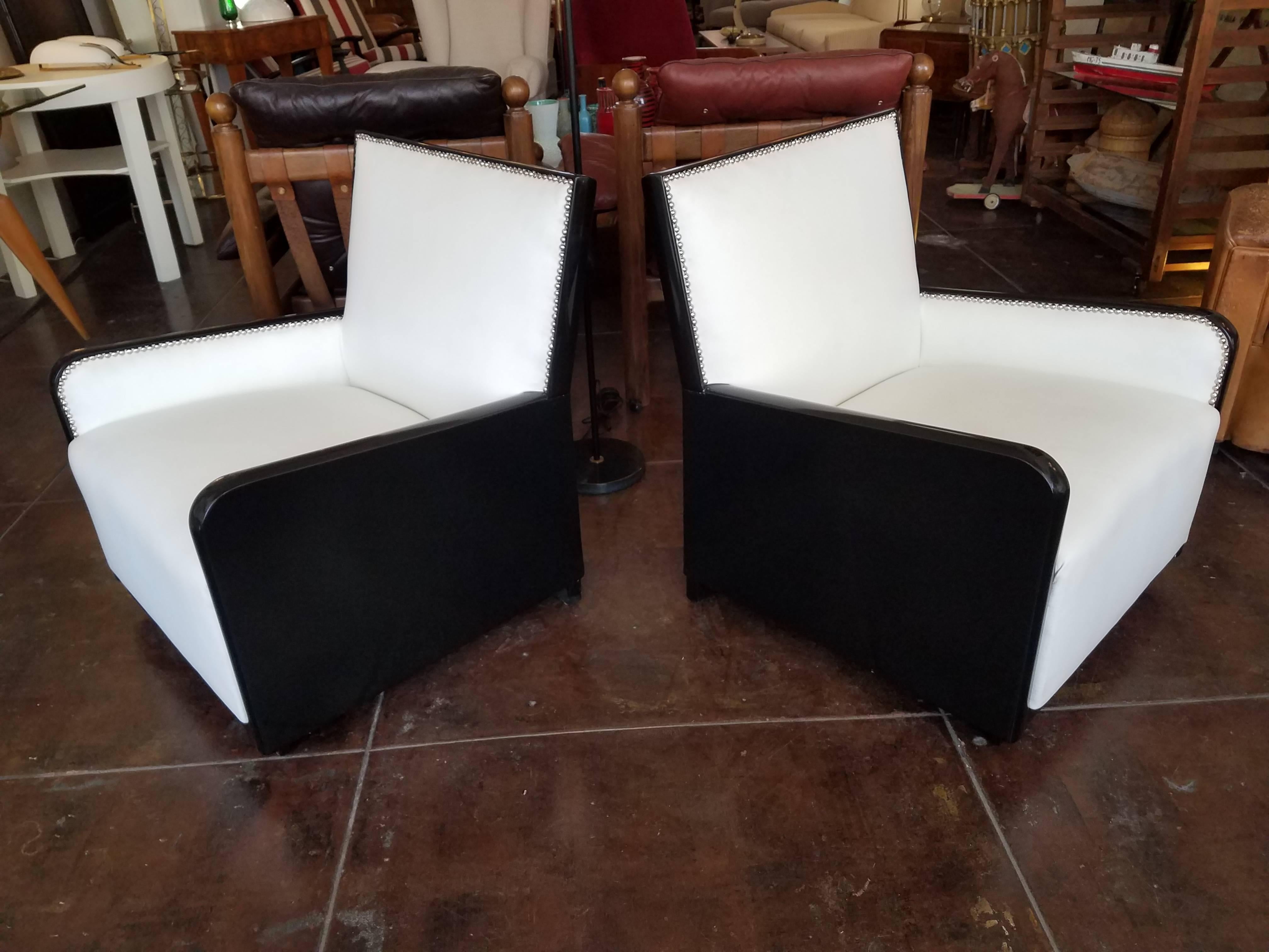 1930s French chairs, black ebonized reupholstered in white Pana Cotta leather.