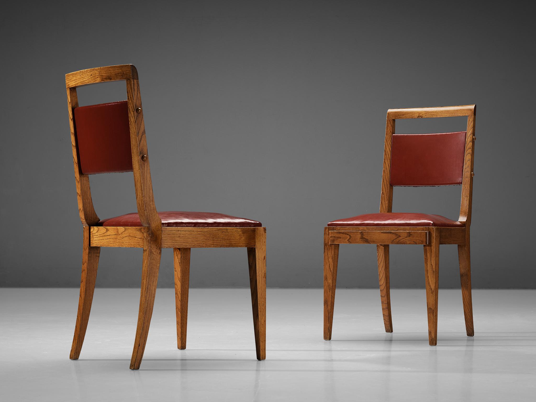 Pair of dining chairs, oak, leatherette, France, 1930s/1940s

These French dining chairs employ the stylistic traits of the French Art Deco in the period of the 1930s and 1940s. In addition, the design reminds of the works by French master Charles