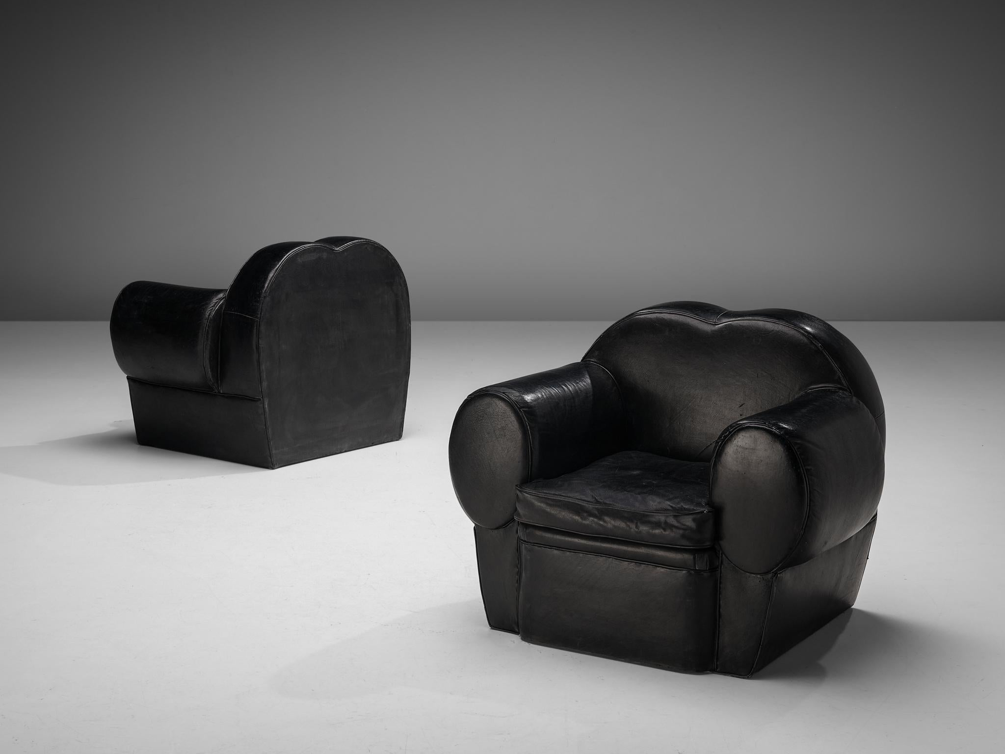 Pair of lounge chairs, leather, France, 1940s 

The designer of these lounge chairs embraced the stylistic traits of the Art Deco period of the 1930s and 1940s. The frame is composed of imposing curved lines and round edges, contributing to the