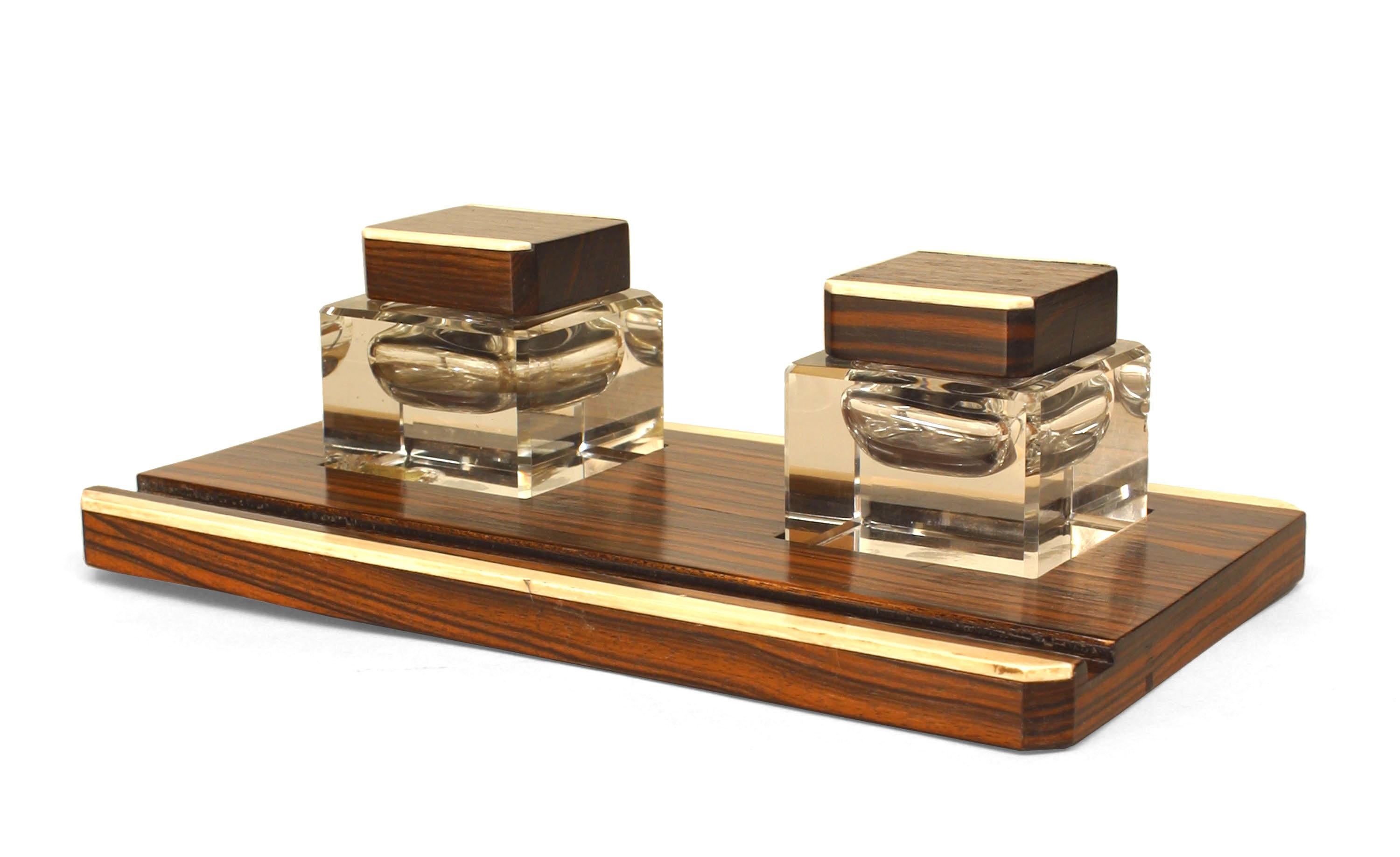 French Art Deco three piece desk set composed of bone-trimmed palisander wood. The set includes a double inkwell, blotter, and roll blotter.