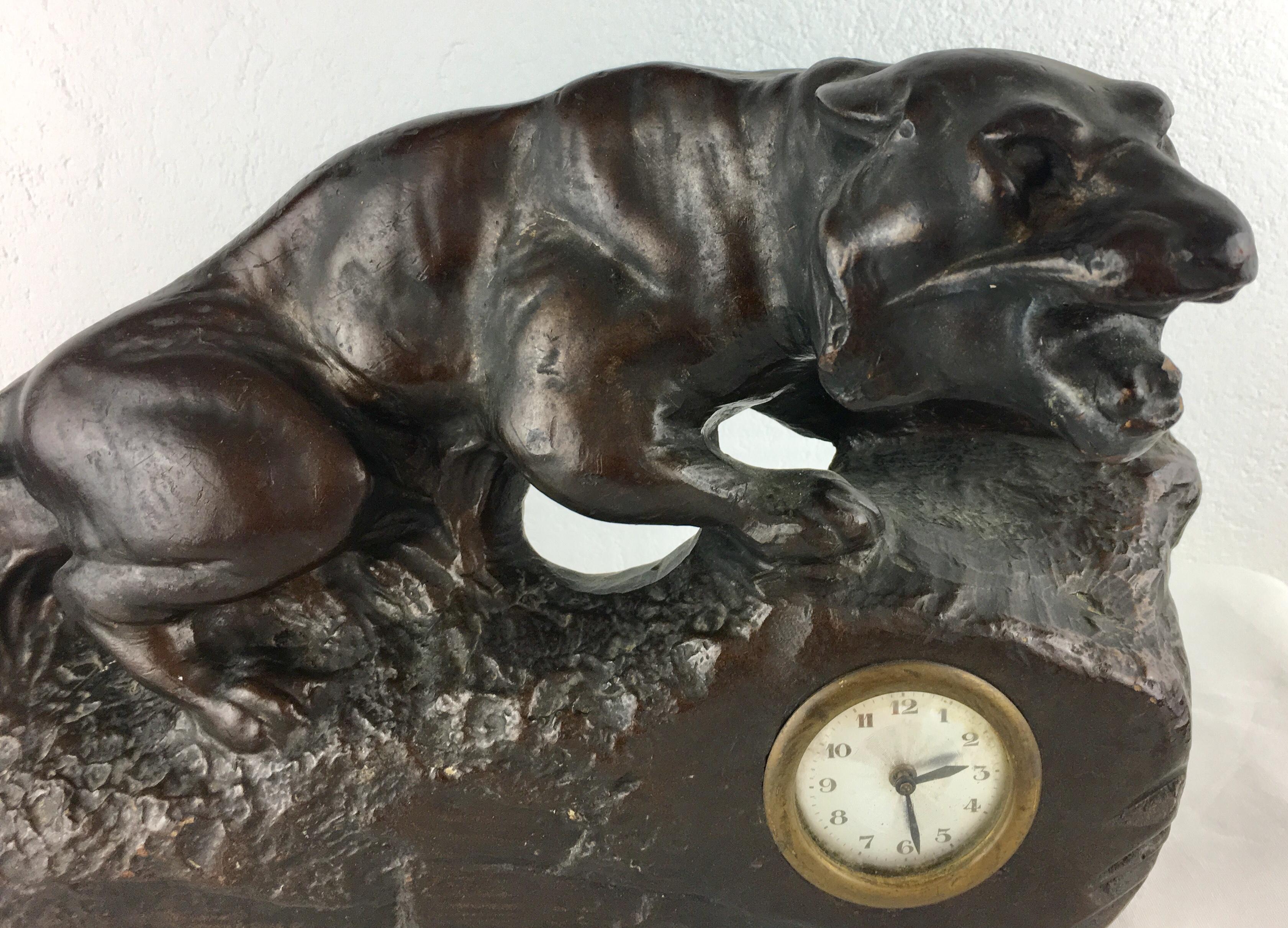 A beautiful French Art Deco enameled terracotta or possibly spelter panther sculpture and clock. Very good condition, circa 1930. Originates from the city of Nancy known for its Art Nouveau and Art Déco movement and styles, which was home to much of