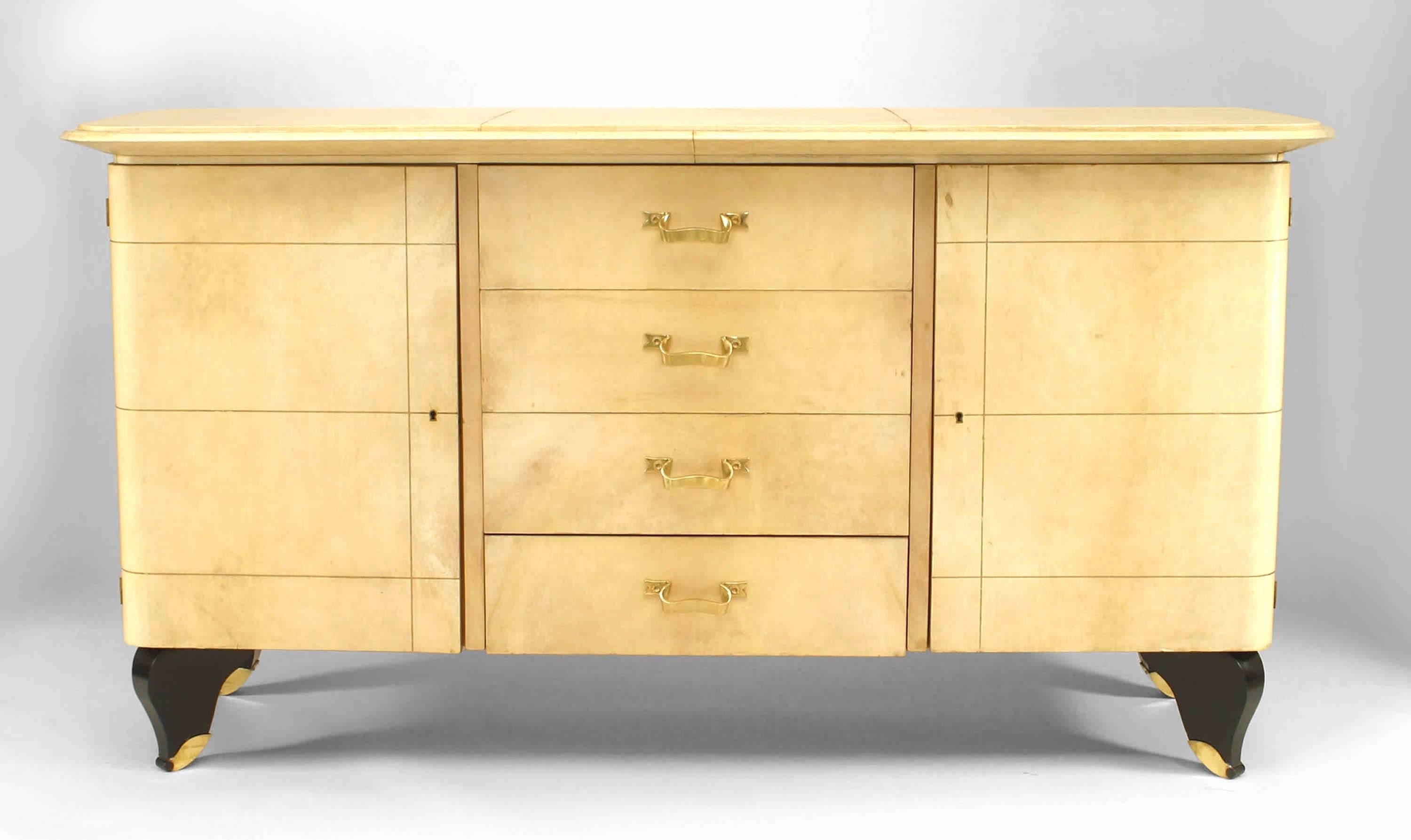 French Mid-Century (1940) parchment sideboard with doors flanking 4 short drawers and black lacquered feet (JACQUES ADNET; bronze handles & trim att: GILBERT POILLERAT, ref: pg 73)
