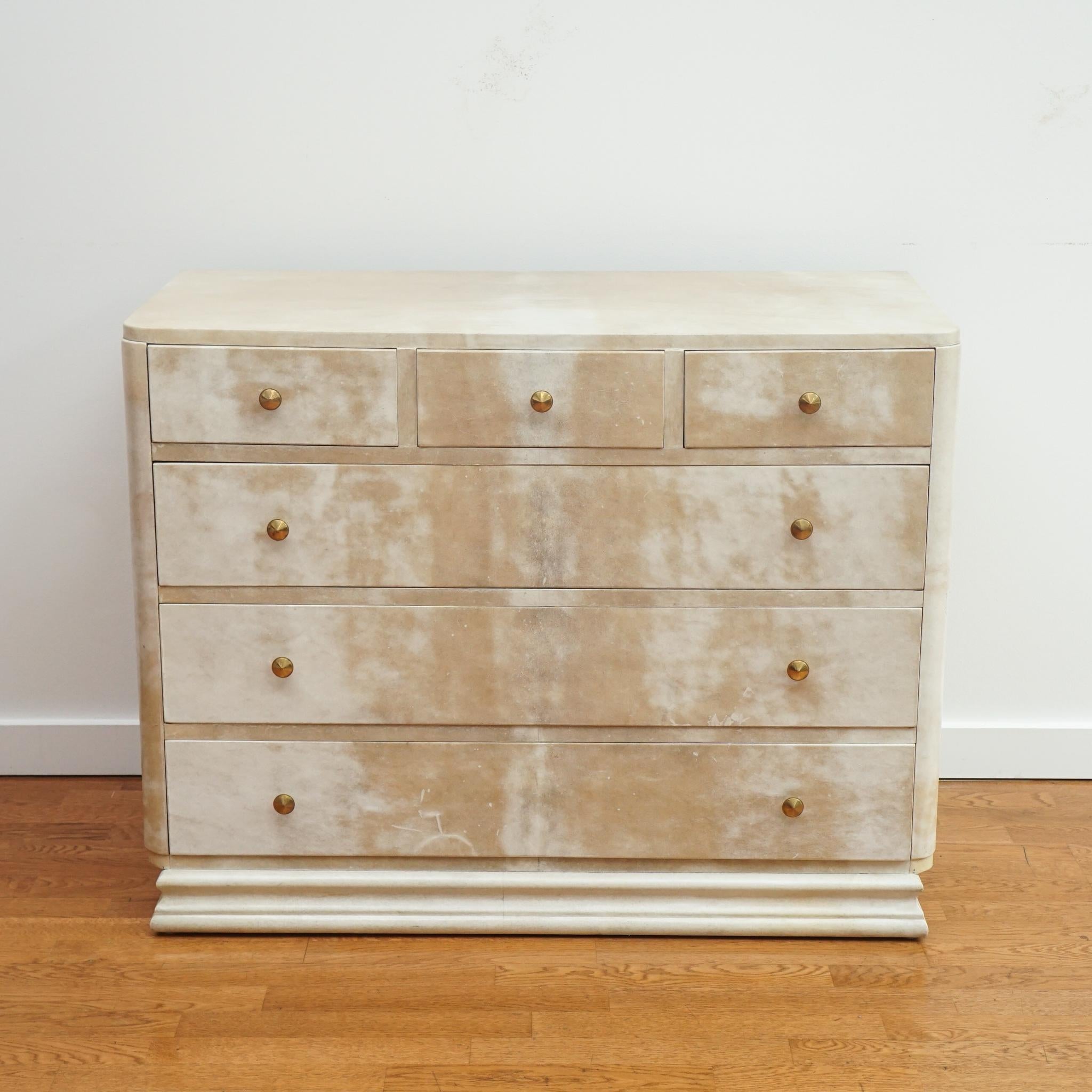 The French Art Deco dresser, shown here, is in the style of Samuel Marx and dates back to the 1940s.  Featuring abundant drawer storage, the dresser is distinguished by its clean lines, gently rounded corners and original parchment finish.  Simple