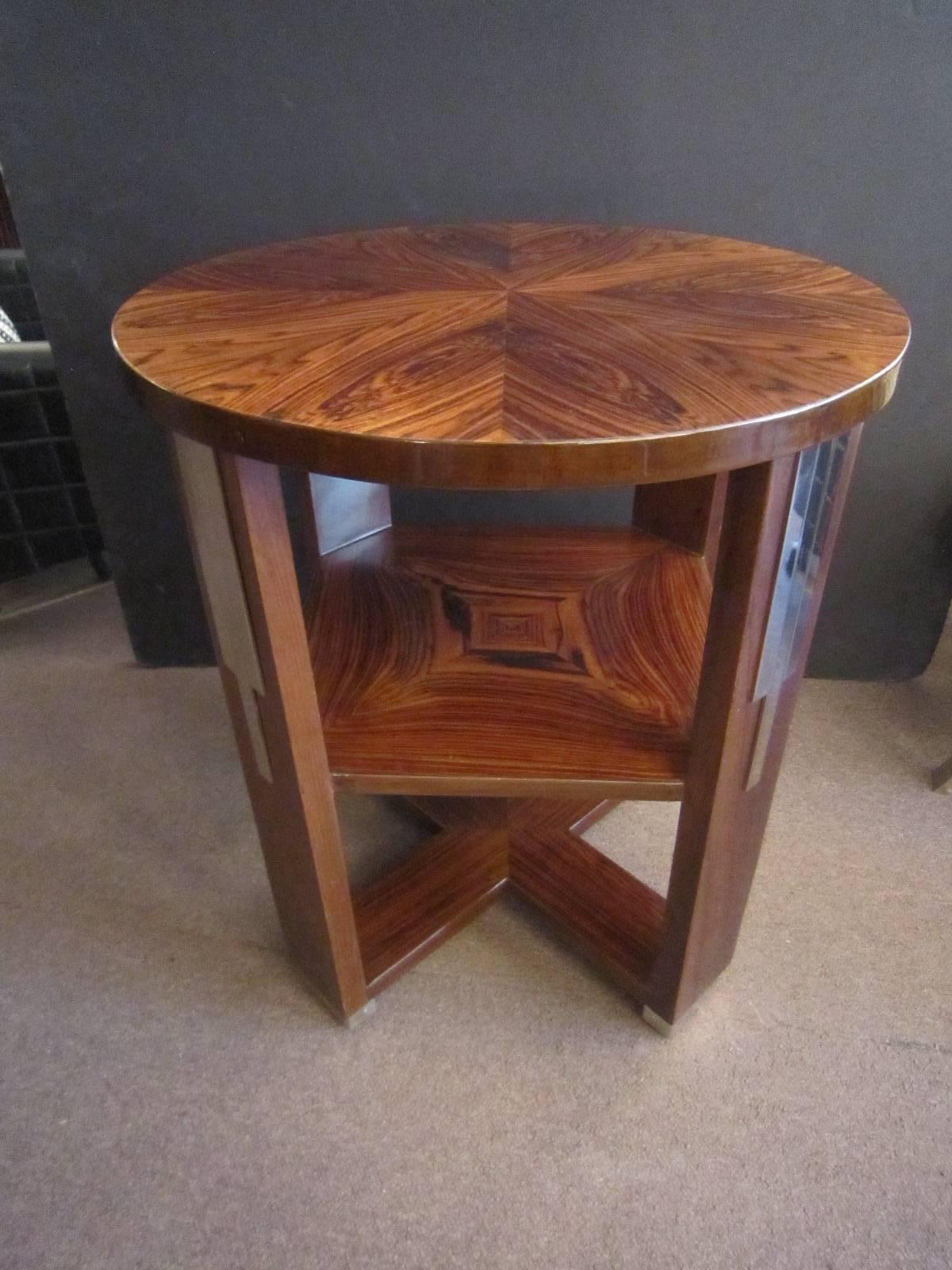 An original and unique French modernist highly figured and inlaid side table featuring round top with square stretcher shelf. The bookmatched rosewood inlay displays it's specimen quality in heart shaped and star patterns. The legs are highly