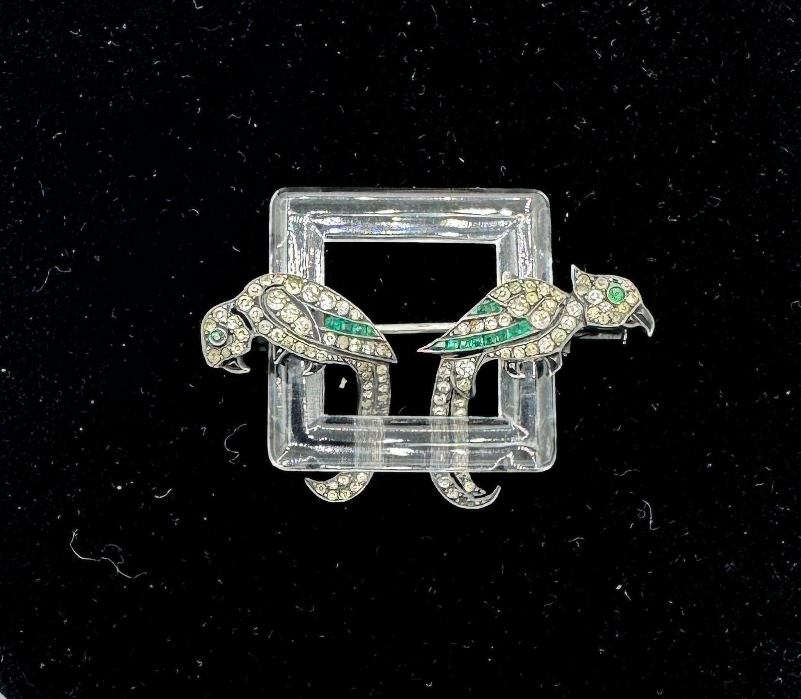 This is a stunning antique Art Deco French Parrot Bird Brooch with a Rock Crystal square frame perch, two parrots in Sterling Silver with paste and Black Onyx adornment.  The brooch is signed with the French Eagle's head for Sterling Silver as well