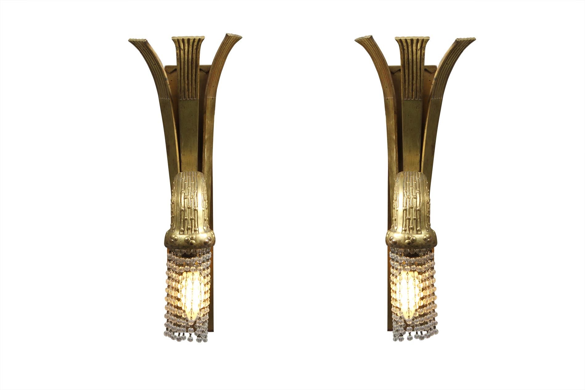 Pair of French Art Deco sconces in gold bronze and glass pearls by the designer Paul Follot, circa 1930. Original pieced that has been rewired. Paul Follot is an important figure of the Art Deco, he distinguished himself at the Salons des Artistes