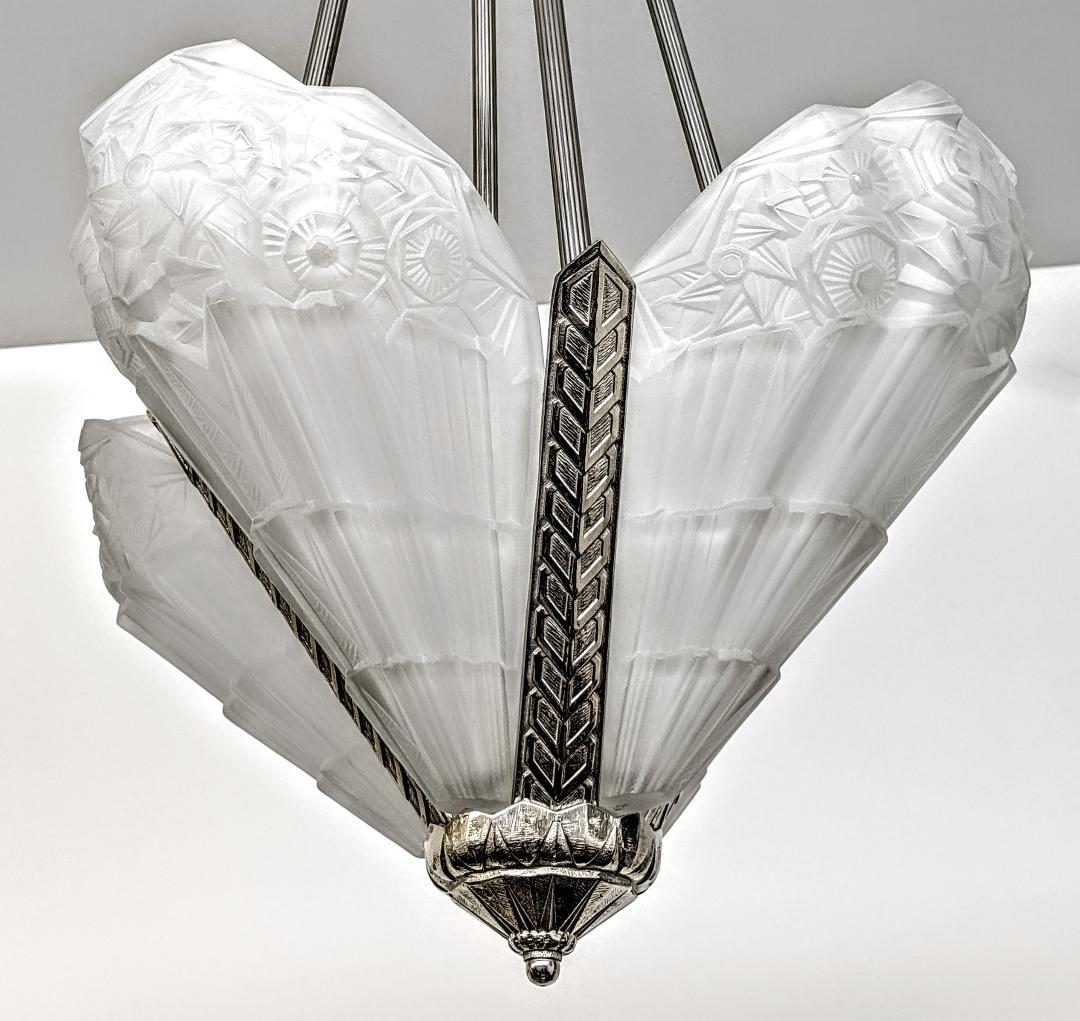 A gorgeous French Art Deco chandelier, pendant by the French artist J. Robert in great condition. The chandelier consists of four-sided shades in clear frosted glass with geometric and flower motif details. Each shade is marked J. Robert. Mounted on