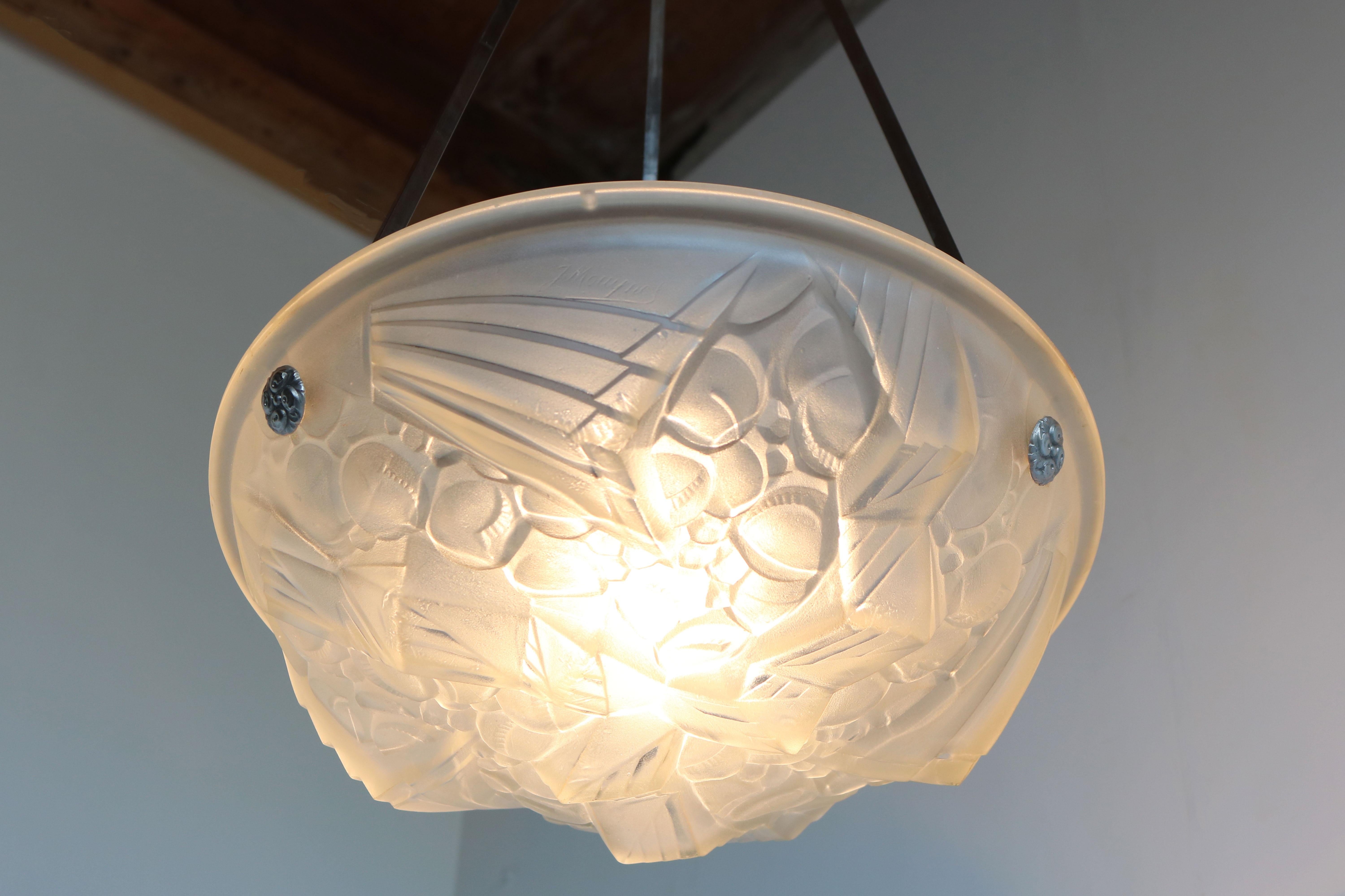 Amazing French Art Deco pendant chandelier by Mouynet (Paris), France, late 1920s. 
White frosted glass shade with a stunning Geometric Art Deco pattern. 
The frosted shade has been hand cut to display a gorgeous scenery when lit , the light