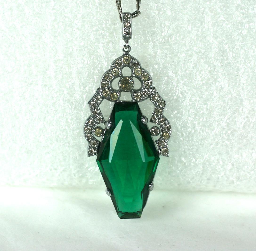 French Art Deco Faux emerald and crystal paste pendant necklace. The elongated hexagonal faceted glass stone set in rhodium plate with vari sized round crystal stones set in base metal.  Fine incised paper clip chain.
Length 2 1/8