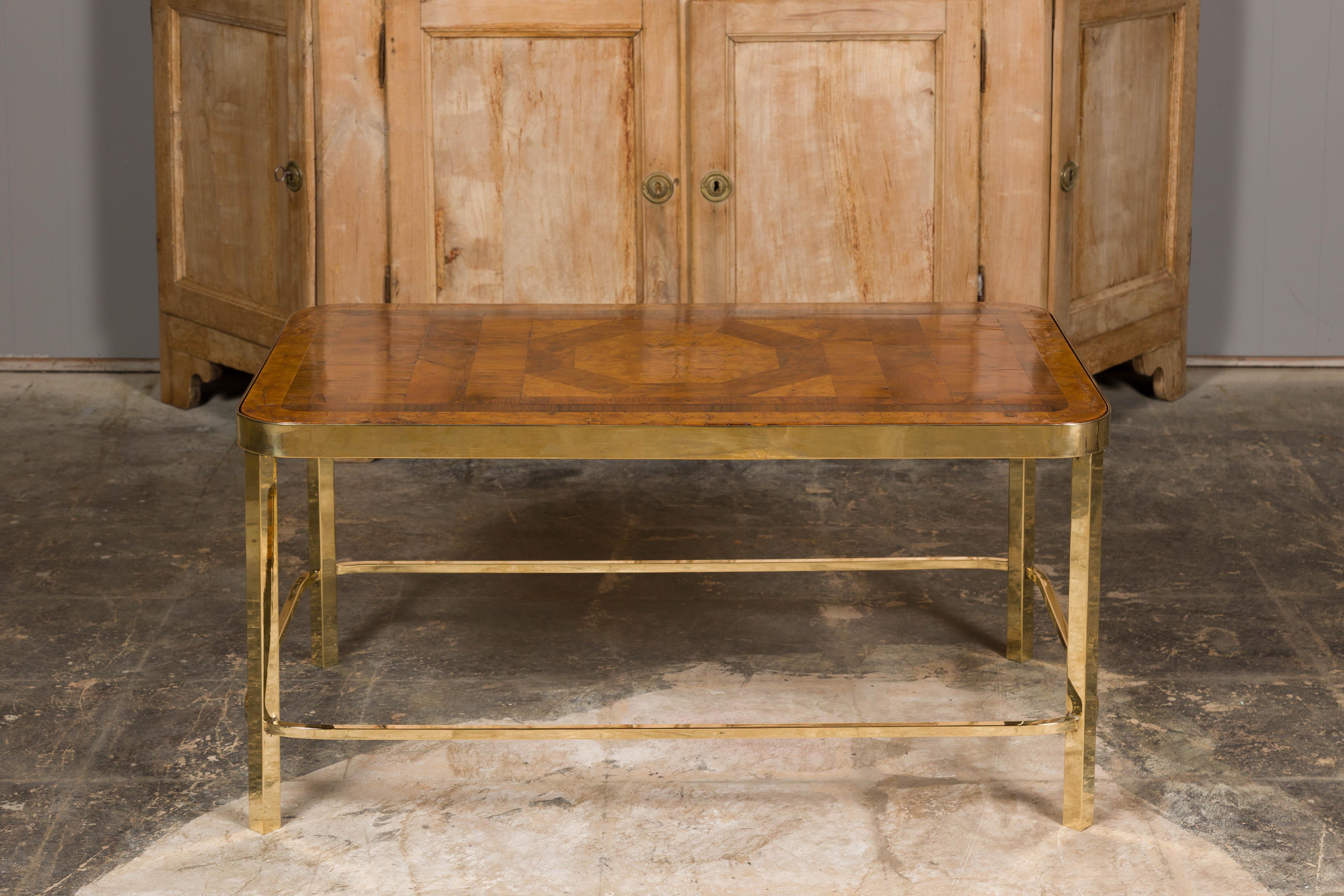 A French Art Deco period coffee table from circa 1930 with parquetry top and brass base. Elevate your living space with this exquisite French Art Deco coffee table, a timeless masterpiece hailing from the glamorous 1930s. With its striking parquetry