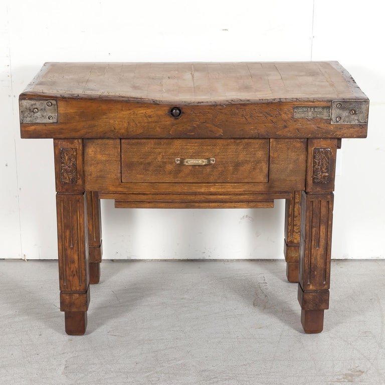 An exceptional 20th century French Art Deco period billot de boucher or butcher block, circa 1930s, handcrafted of mixed woods by the well known Xavier Aubert workshop in Dijon, France. The thick carving surface, with the original USINES X. AUBERT,