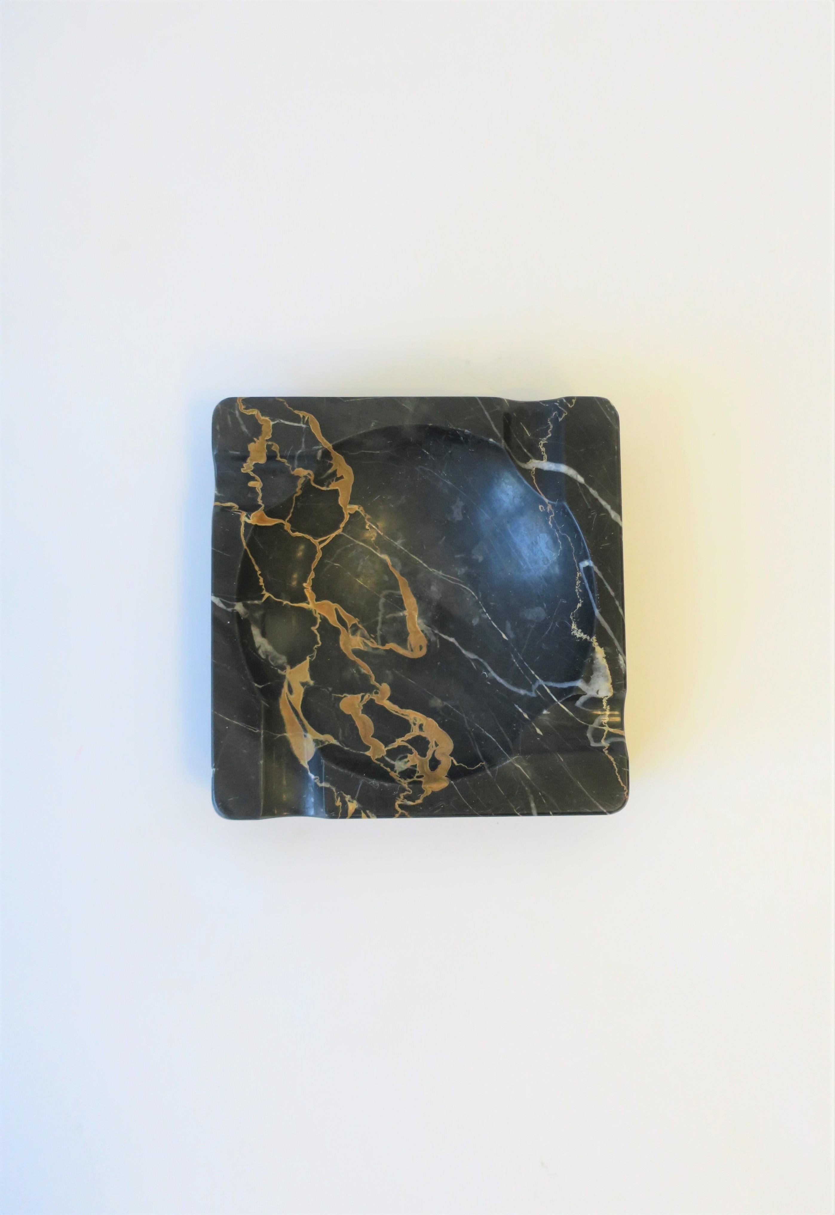 A beautiful and substantial French Art Deco period black marble ashtray or vide-poche (catch-all.) Ashtray can accommodate cigarettes or cigars. Piece is black marble, with tan and white veining, aka as 'Portoro Marble'. As show in images, piece can