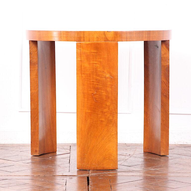 French Art Deco period round side or occasional table of simple geometric form, the top with book-matched figured walnut top and standing on three curved thick plank legs. 


 