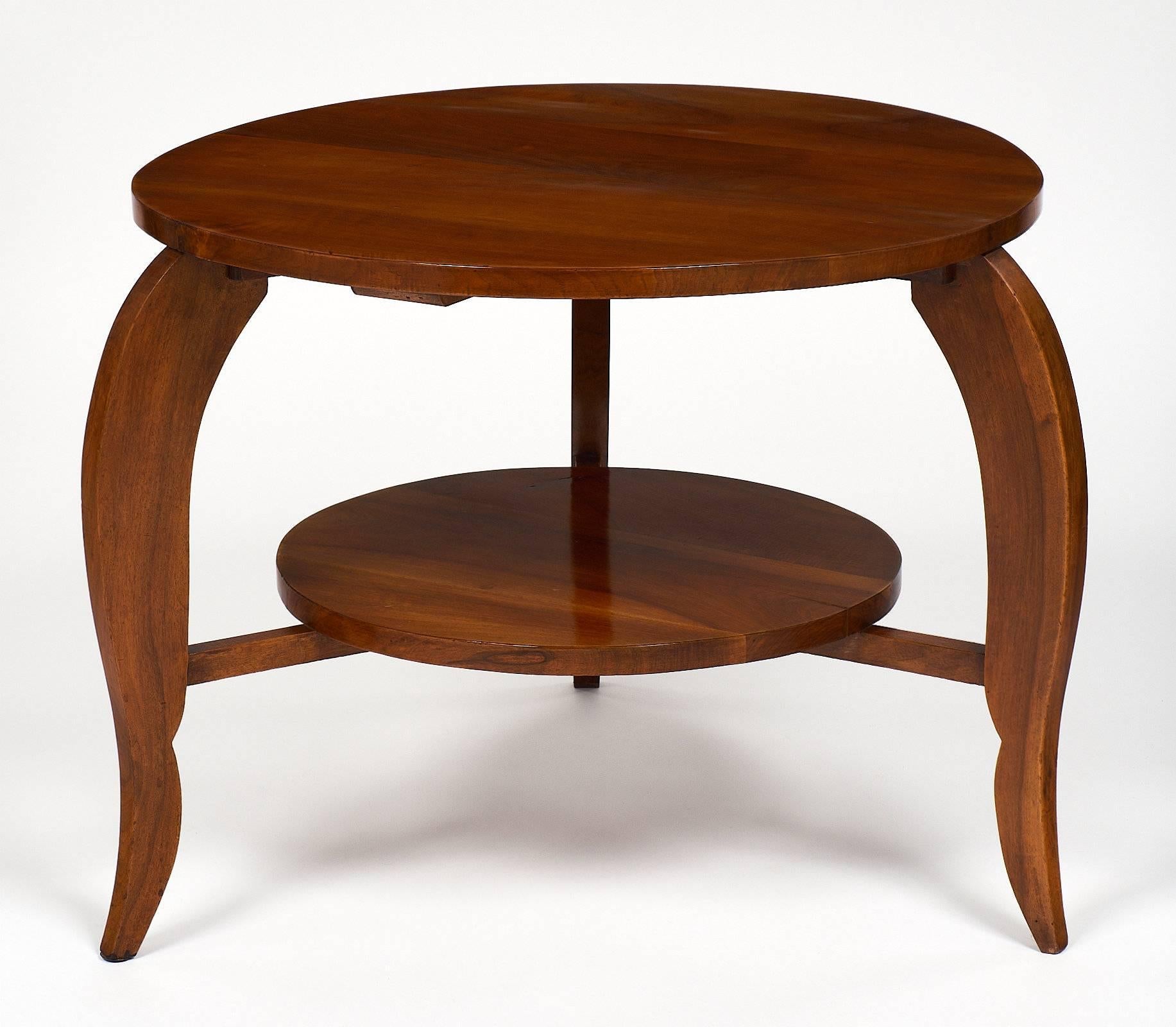 French Art Deco period “gueridon” with walnut veneer; three cabriole legs and a bottom shelf. We loved the dynamic lines of this versatile round side table; and the honey-toned color of the walnut; finished with a French polish.