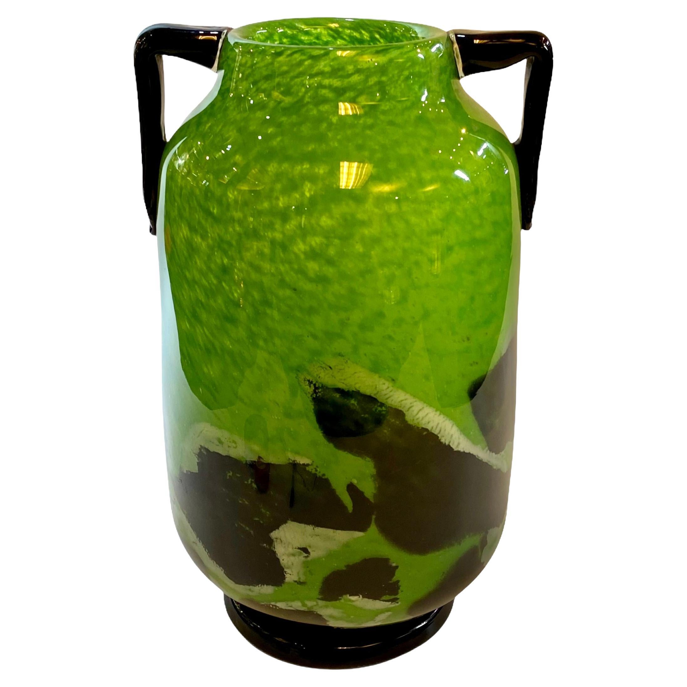 Our French Art Deco period vase from Degue in mottled green and black glass with applied handles measures 16 1/4 in, 41.3 cm tall.  It is in very good condition with light scratches and scuffs.  Engraved on underside in script 