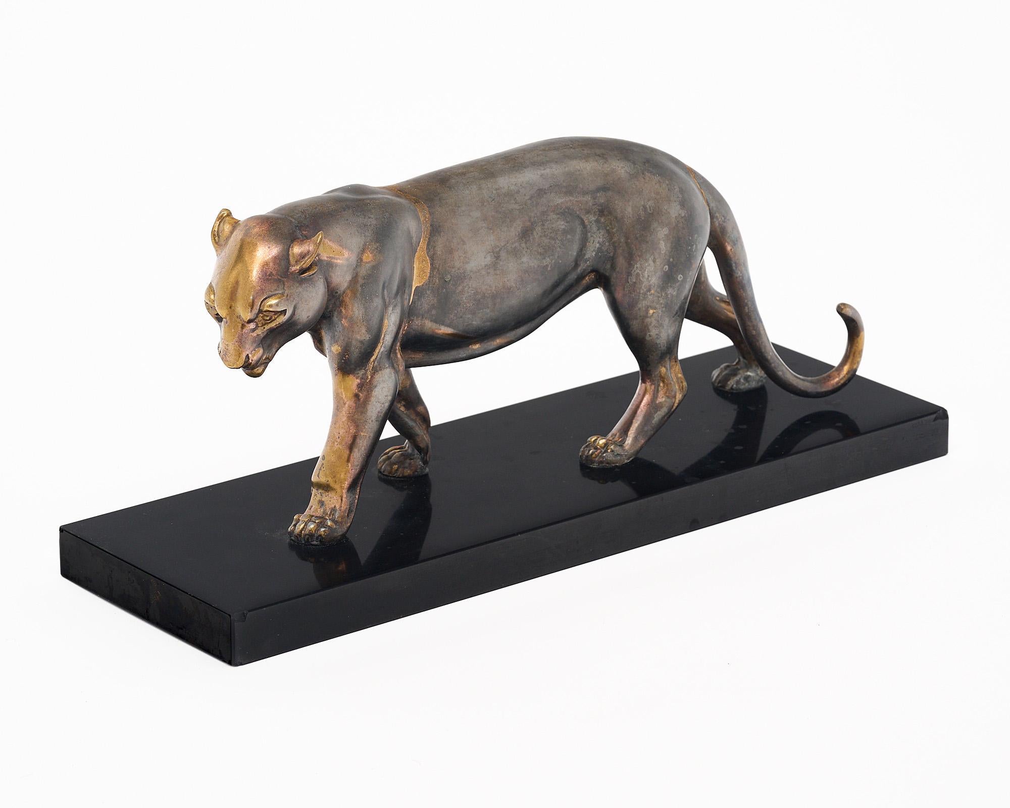 Sculpture of a panther from Art Deco period France made of metal with a black marble base. This figure is in a natural walking pose and is quite eye catching. It features the original patina consistent with use and age.