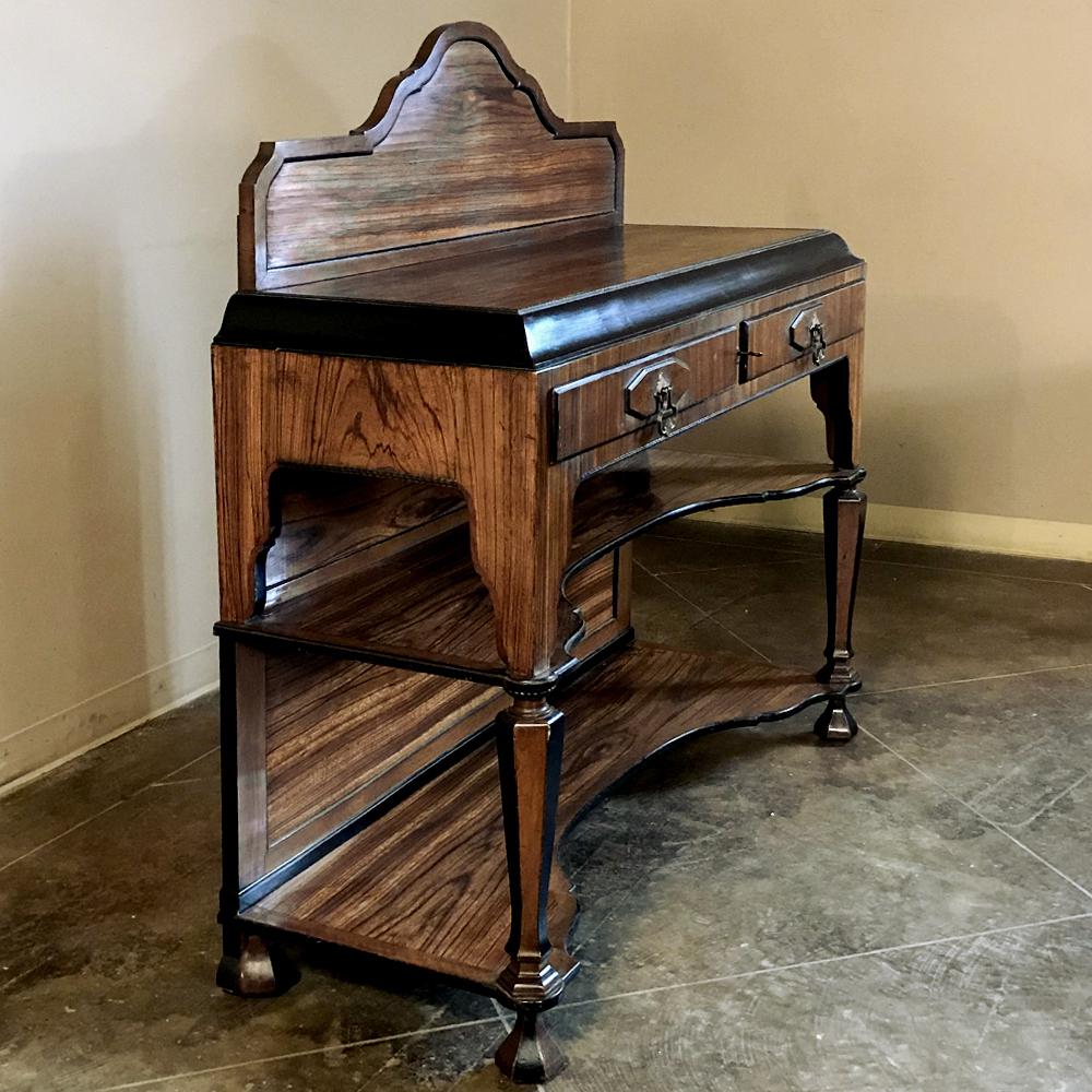 French Art Deco Period Rosewood Buffet features exotic rosewood veneers atop a timeless framework which provides three surfaces, with ebonized molding providing a framework for the beautifully grained imported wood. A pair of drawers add a nice