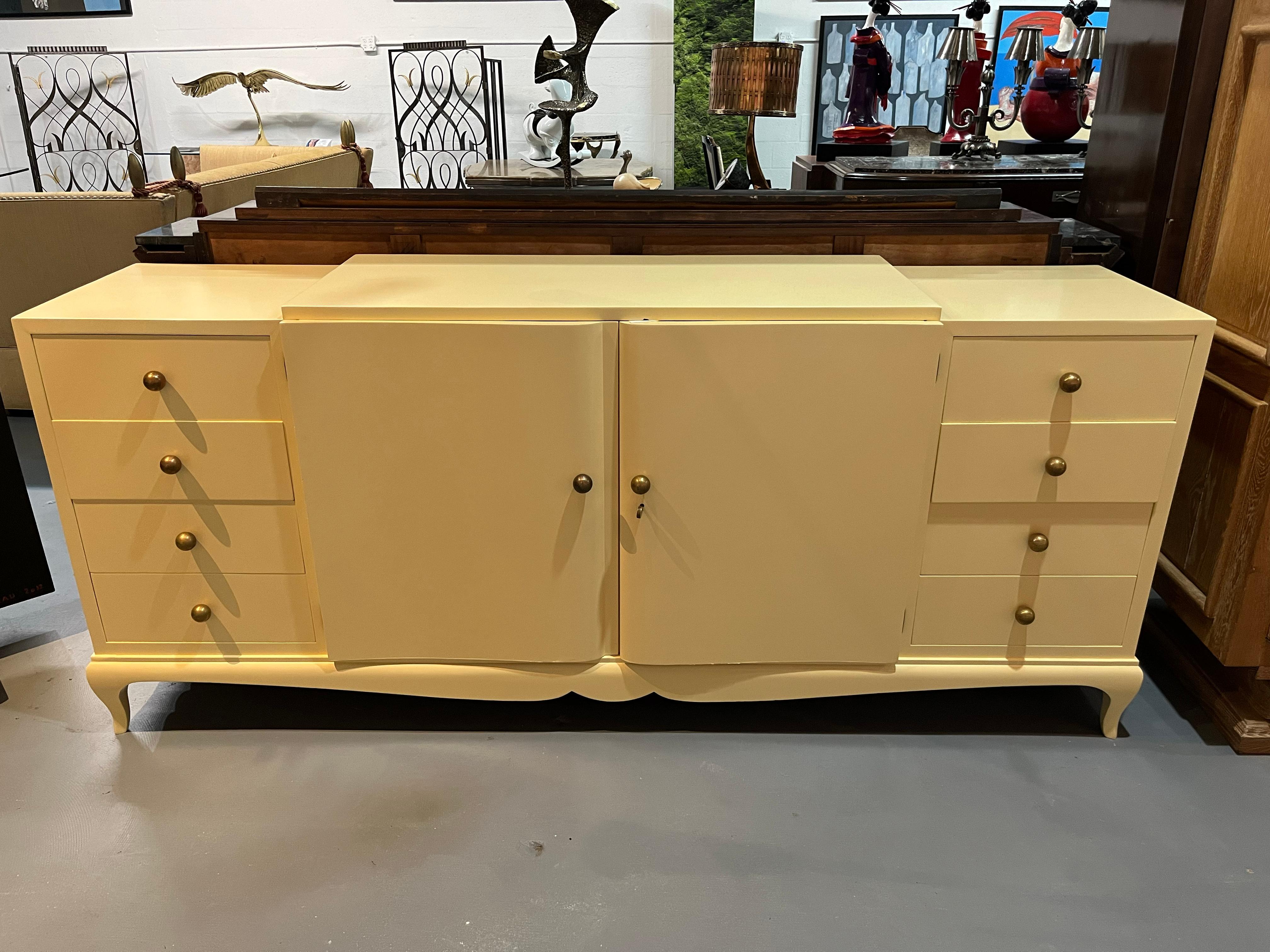 This timeless and sophisticated sideboard was created in the style of celebrated 20th century sculpter and architect André Arbus. A master of simple elegance, The ivory lacquered wood of the chest has a smooth finish that gives a beautiful shine in