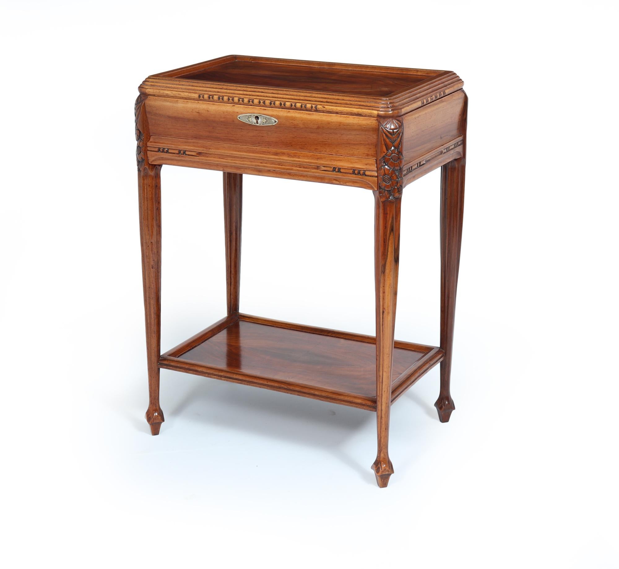 ART DECO DRESSING TABLE 
A beautiful French Art Deco lift-up lid dressing table, a stunning piece crafted from solid walnut. The intricate carved details showcase the artistry of its era, while the cleverly hidden drawer offers an unexpected touch