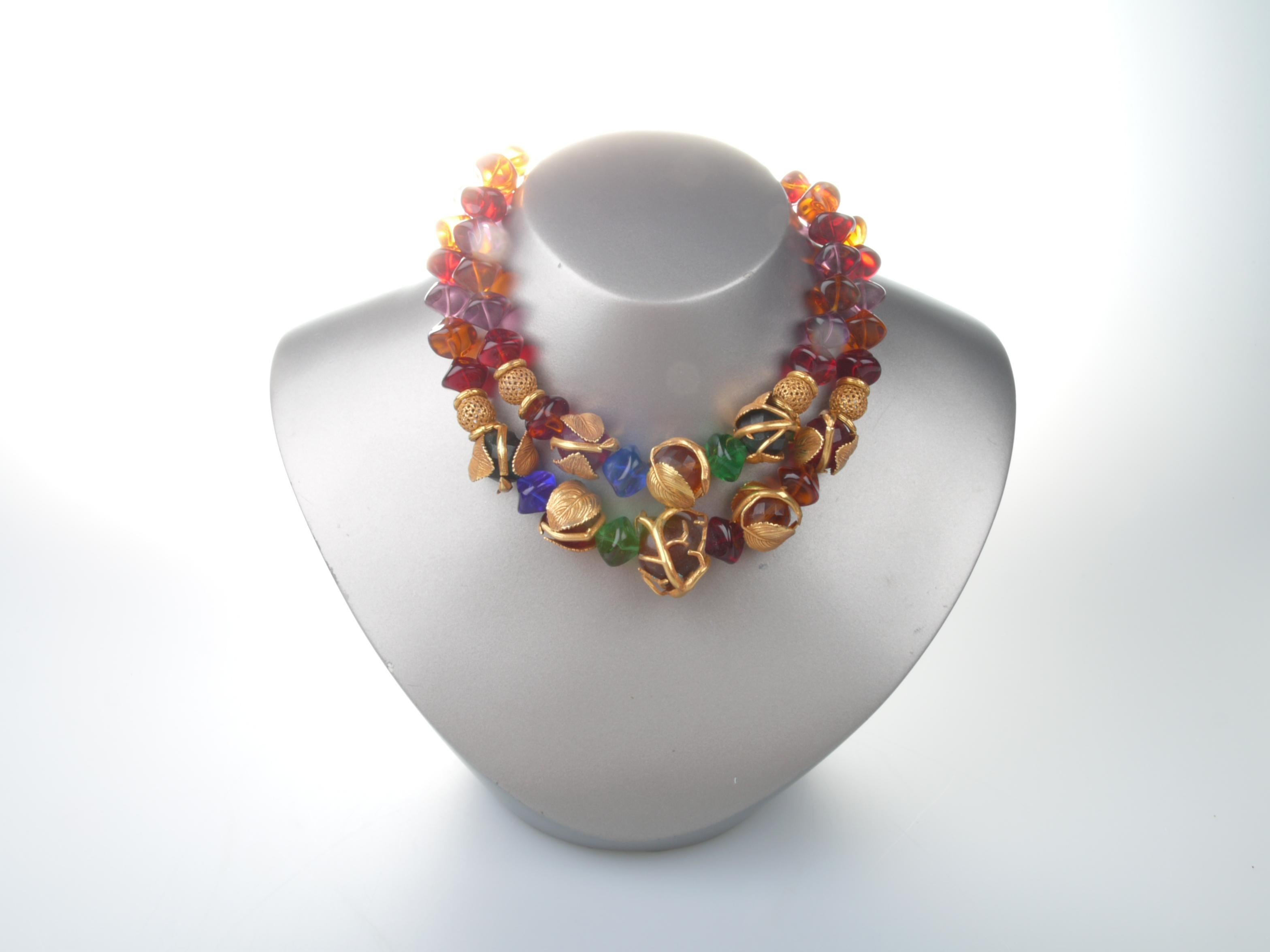 French Philippe Ferrandis multicolored glass bead necklace with various gold dipped metal spacers and beads encapsulated with whimsical gold dipped coverings.
Makers mark attached to the opening.