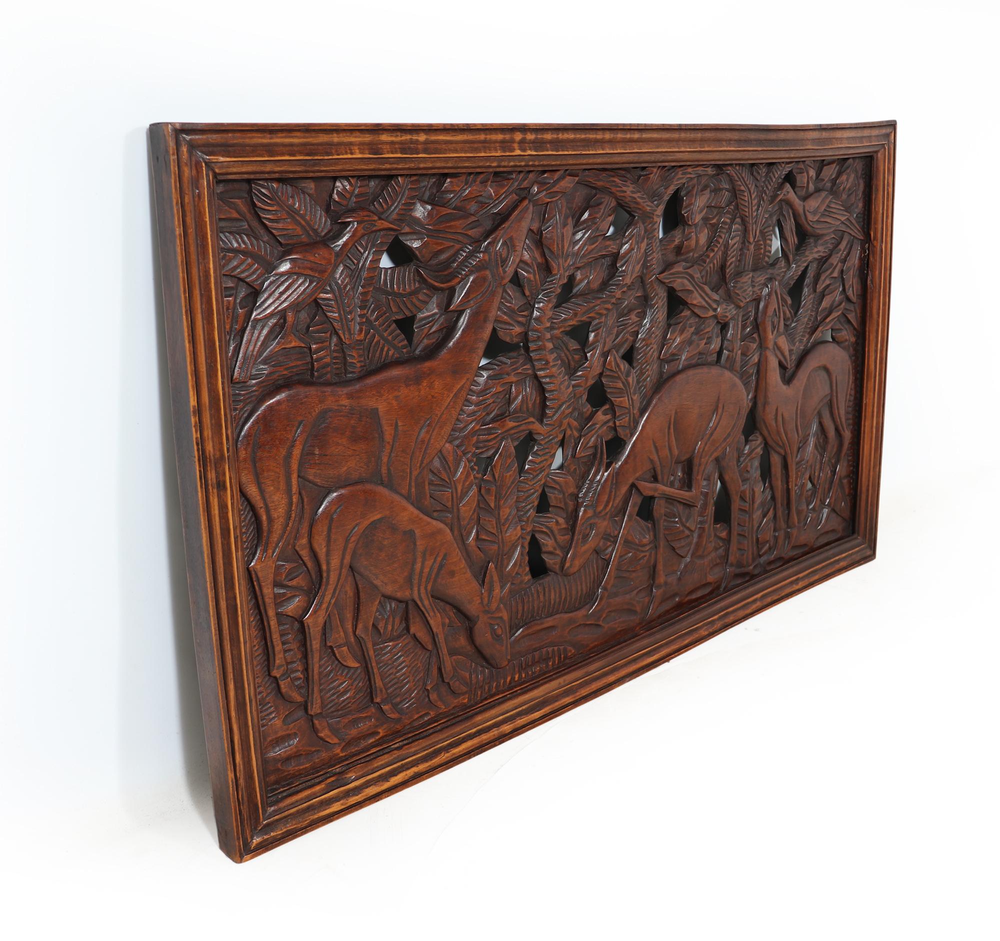 PIERCED CARVING WALL PANEL
This stunning carved oak panel from the 1930s is a true masterpiece, showcasing intricate detailing of gazelles and birds set in a forest scene. The depth of the carving and piercing work on the oak is nothing short of