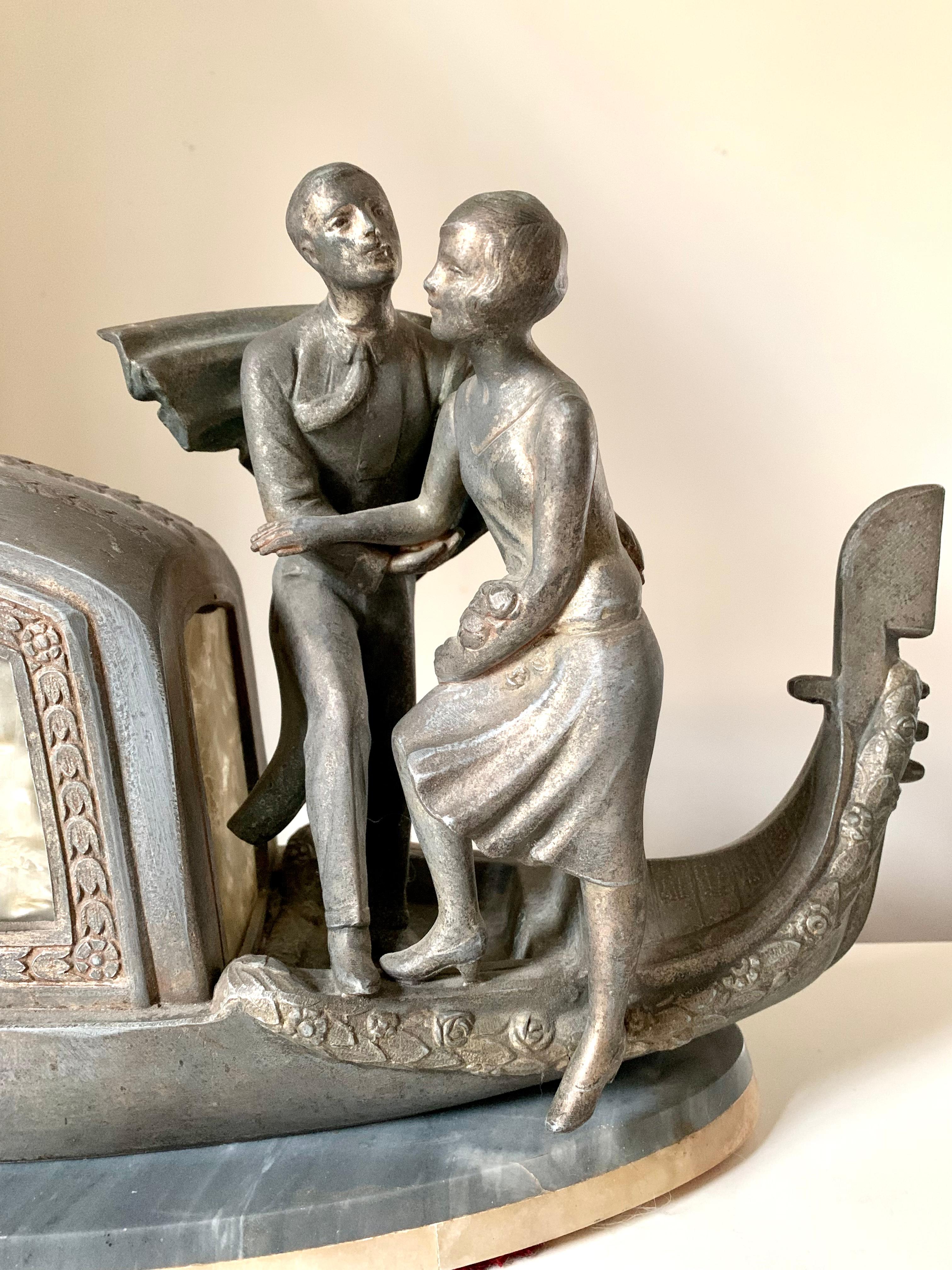 A silvered Venetian goldola, a handsome smiling gondolier, a beautiful couple embarking on a romantic voyage, a fabulous French Art Deco period lamp by Pierre Sega.
Circa 1920
Silvered metal, Saint Anne marble, Honey onyx, celluloid panels
The