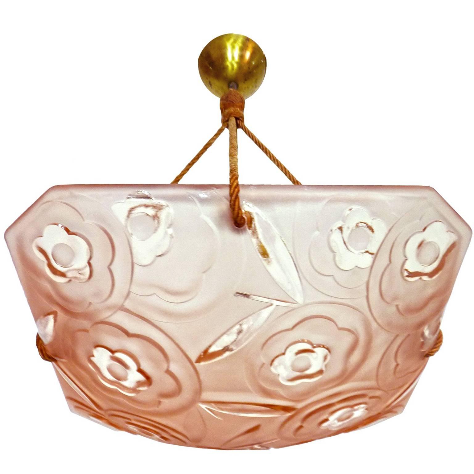 Beautiful French Art Deco chandelier or pendant with pink glass shade with floral and leaf pattern signed by Degué, silk cord
Measures:
Width: 16 in / 40 cm
Diagonal: 18 in / 45 cm
Height: 20 in / 50 cm
Weight 8 lb. (4 kg)
One light bulb E 27