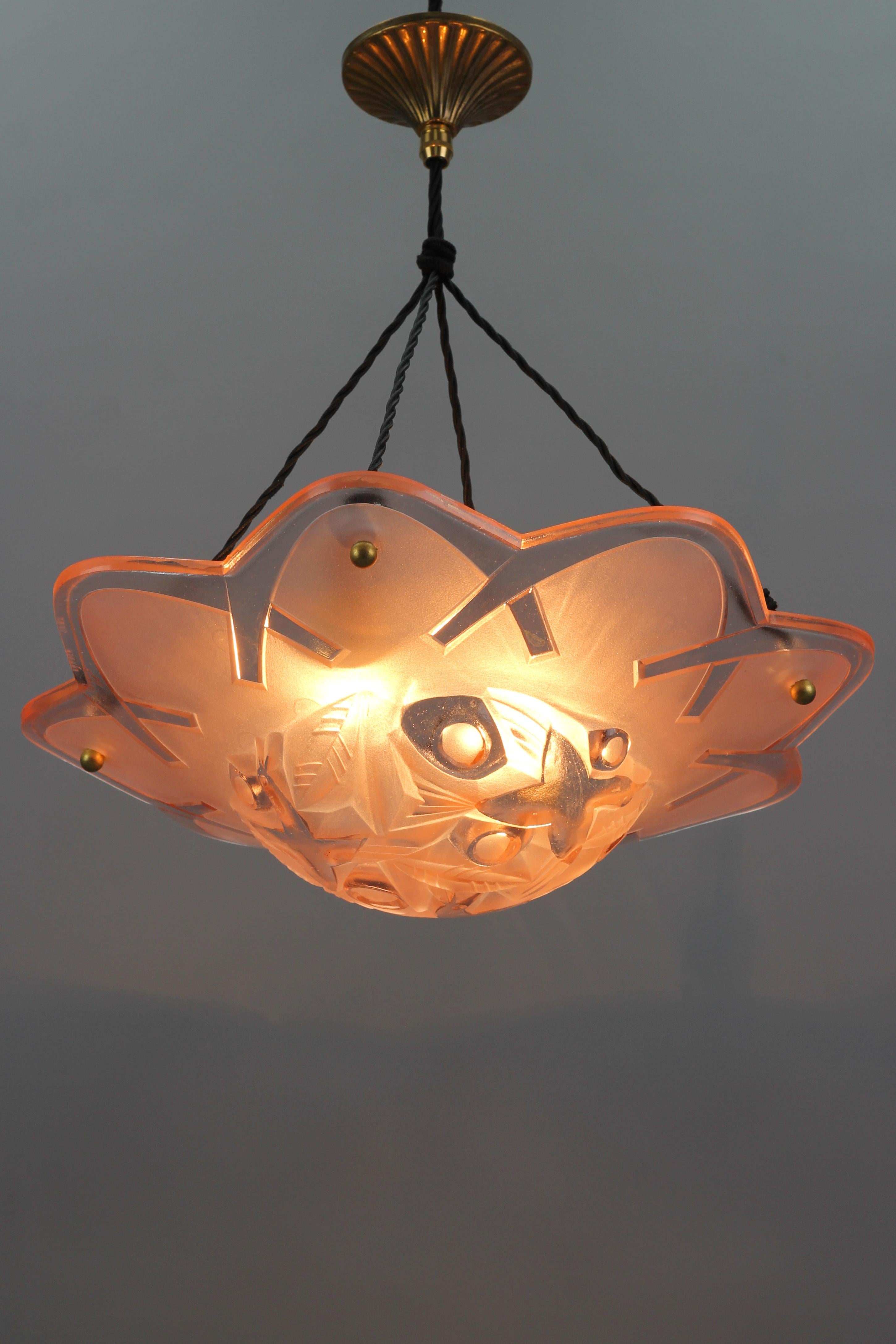 An adorable flower-shaped French Art Deco pendant Ceiling light by David Gueron. This beautiful light fixture features a partially frosted molded glass bowl in pink color with very attractive foliage and three flying birds design in the center of