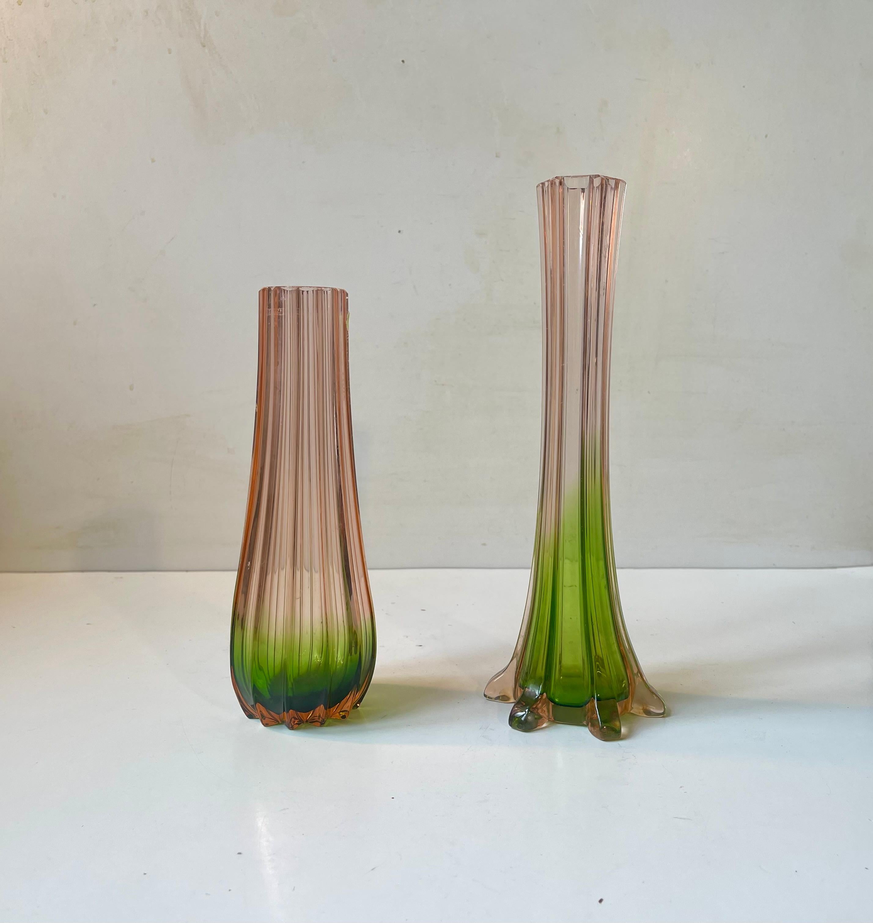 Exquisite French colored glass vases. Pink and green glass or Rubina Verde as they are called in France. Executed with vertical ribbings. Distinct Art Deco styling and vibrant colors. Made in France circa 1920-30. 

Measurements: H: 25.5/21 cm,