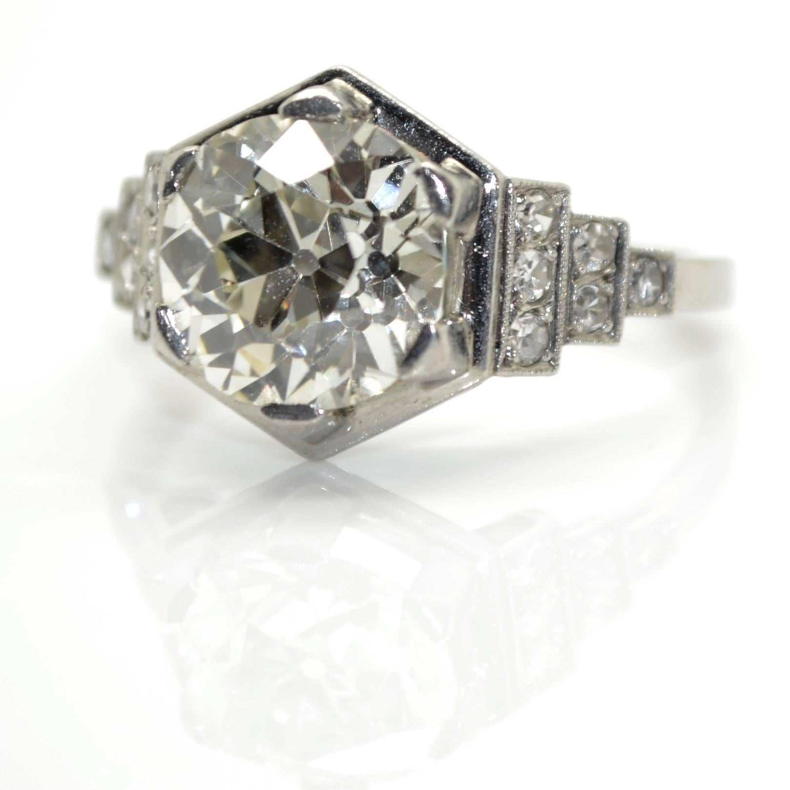 French Art-Deco platinum solitaire ring with graduating stepped shoulders, circa 1930
The central old European cut diamond has an estimated weight of 3,50 carats (J-K color and VS clarity).
This rare hexagonal ring weighting 5,70g is pavé set with