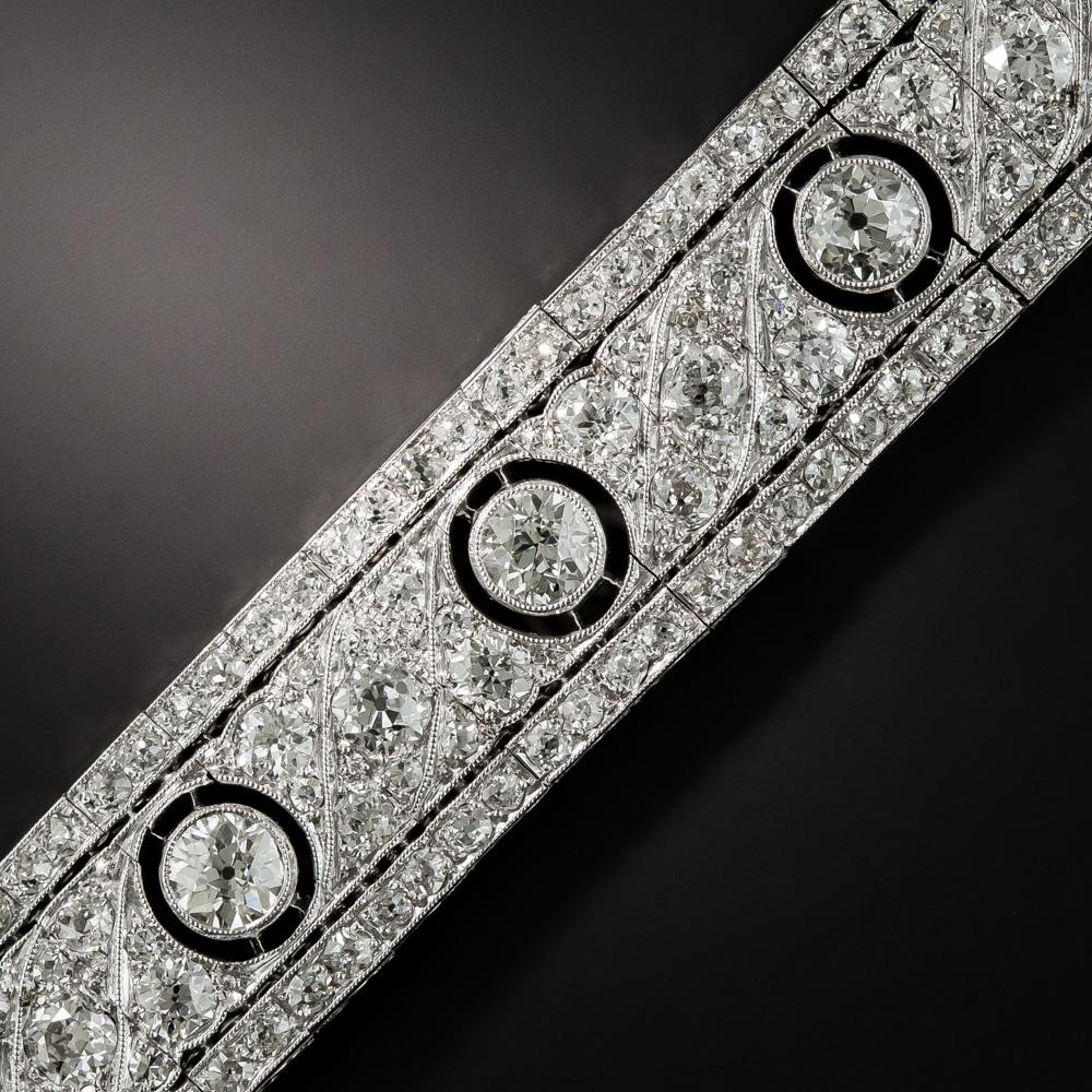 Measuring an eminently wearable 5/8-inch wide, this stunning Art Deco wrist bauble, by way of 1920s France, features nine bright-white and sparkling European-cut diamonds (total weight 5.50 carats). The scintillating bezel-set stones effectively