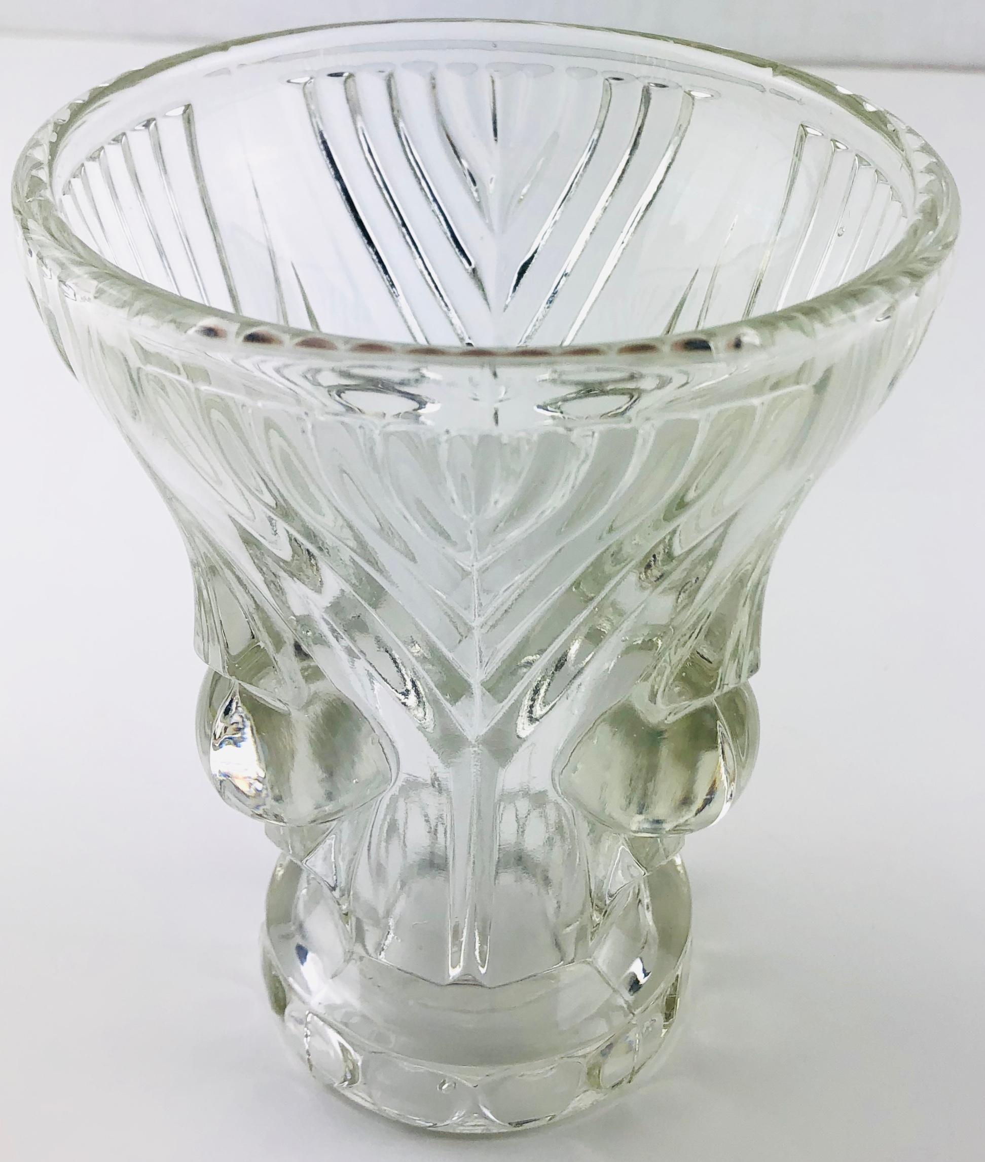 An exquisite small French Art Deco pressed glass vase. Adorned with 1920s-1930s period details, attributed to Lalique. Unmarked. 

The glass is very clear, however, it was challenging to capture the clarity in the photographs. 

Pressed glass is