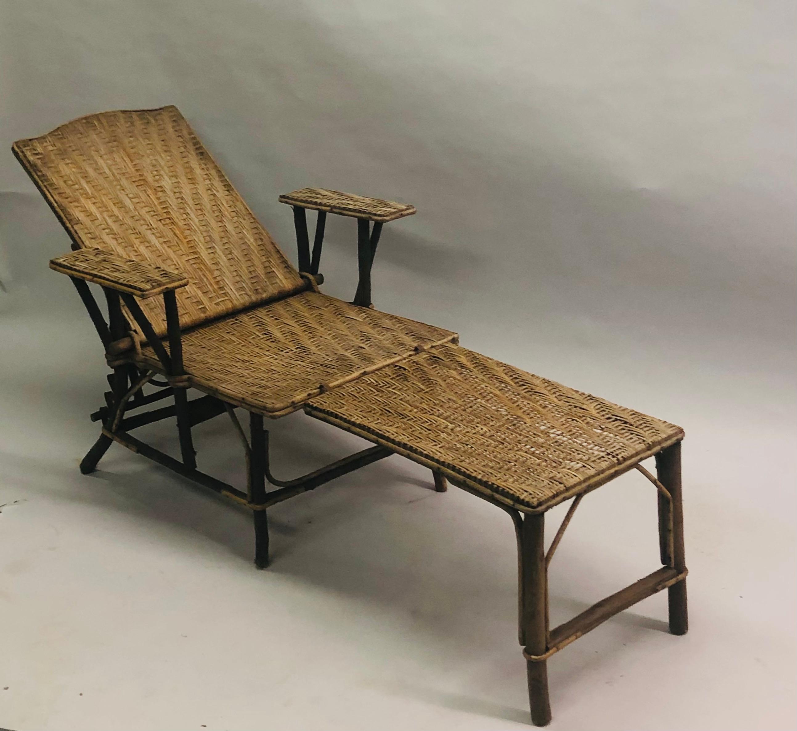 Authentic French Art Deco Chaise Lounge in Bamboo and Rattan circa 1920 with rattan woven in a cubist form and presenting a chic, slender profile. A charming atmospheric piece that add depth and authenticity to any room. The chair and ottoman attach