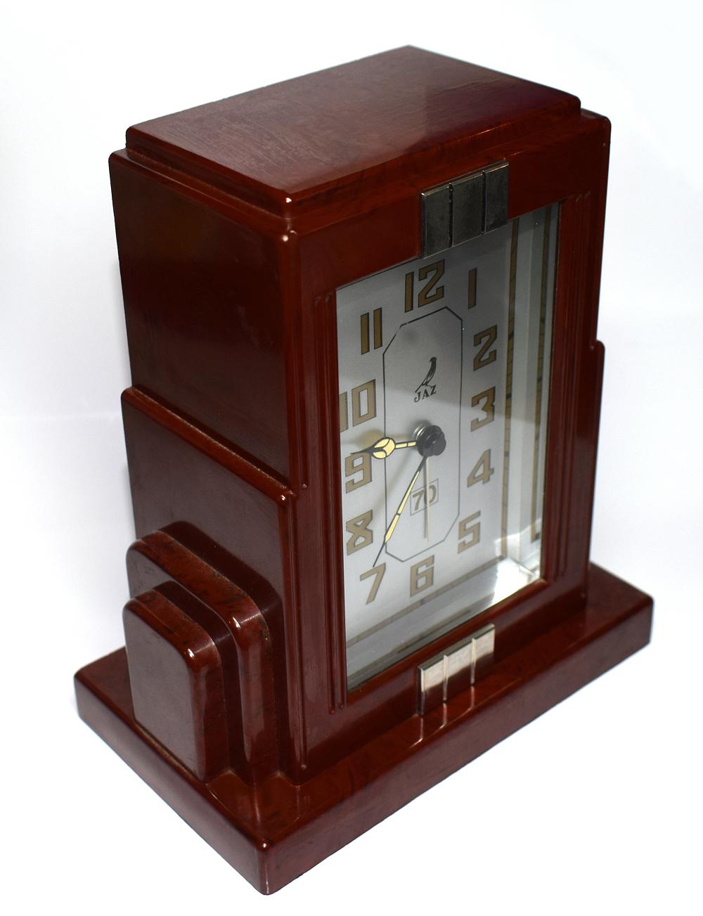 Fabulous Art Deco clock by Jaz a French clock maker. This clock is in a deep cherry red with black speckles and wonderful skyscraper shaped casing. The condition of the face is particularly good showing little to no signs of its true age. The