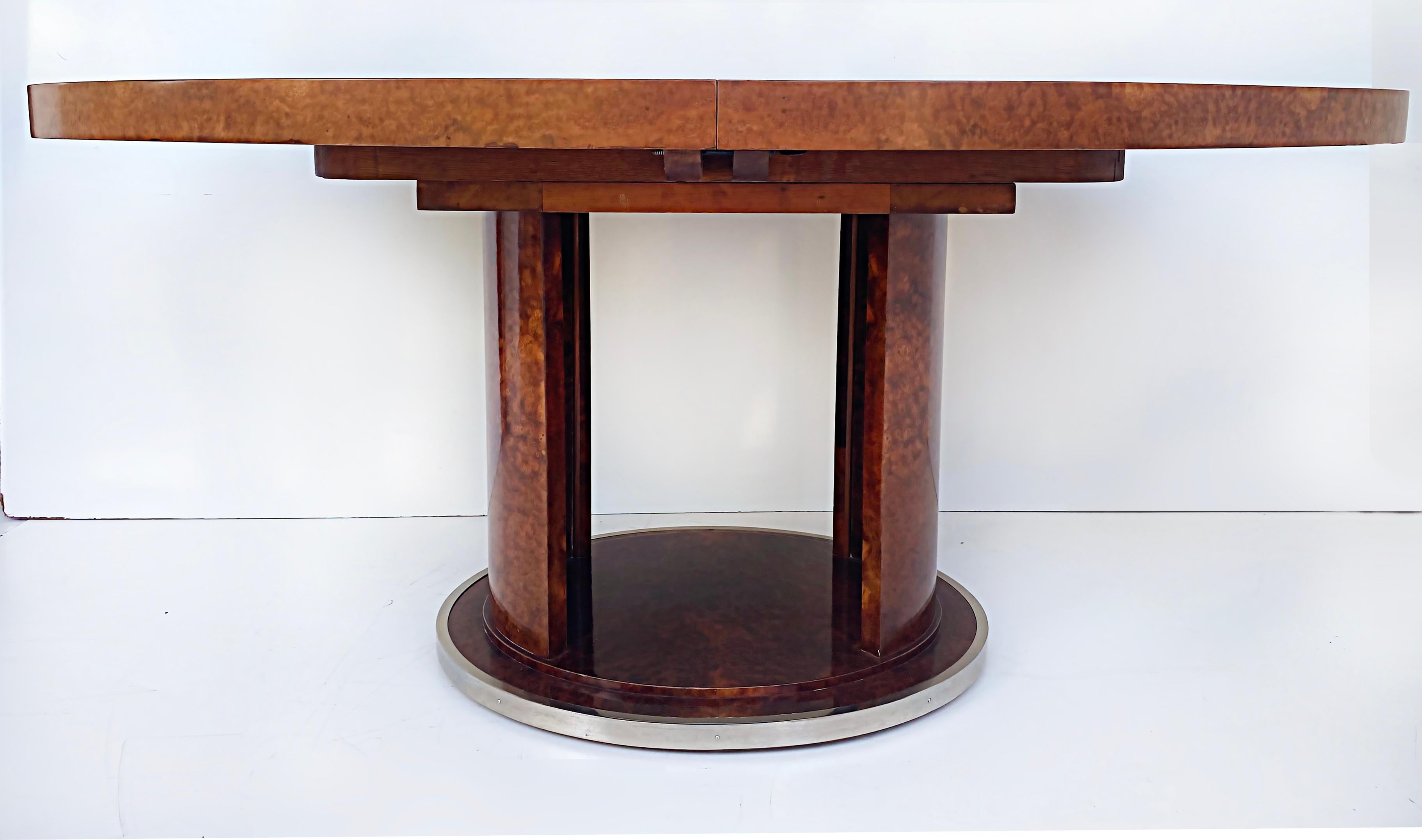 French Art Deco Rinck Paris Burlwood Dining Table 1930s, Extending Oval Pedestal

Offered for sale is a French Art Deco oval extendable dining table marked with the E. Rinck Paris stamp dating and documented to be from the 1930s. This wonderful