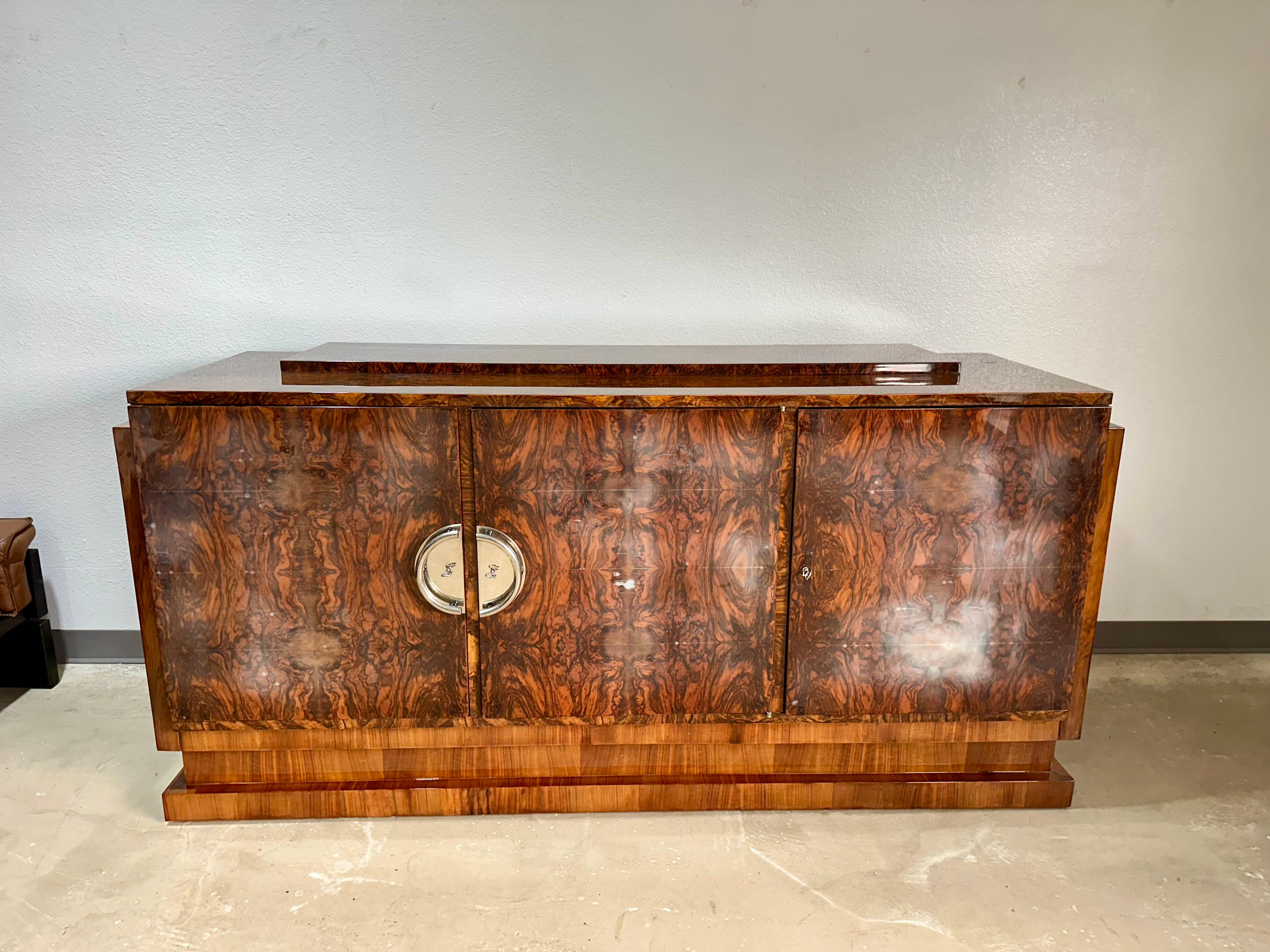 1930’s French Art Deco Lacquer Credenza/Sideboard in highly figured rosewood veneers and walnut with chrome handles. An exceptionally crafted and well built piece with stunning rosewood veneers, unfortunately was improperly stored and has blushing