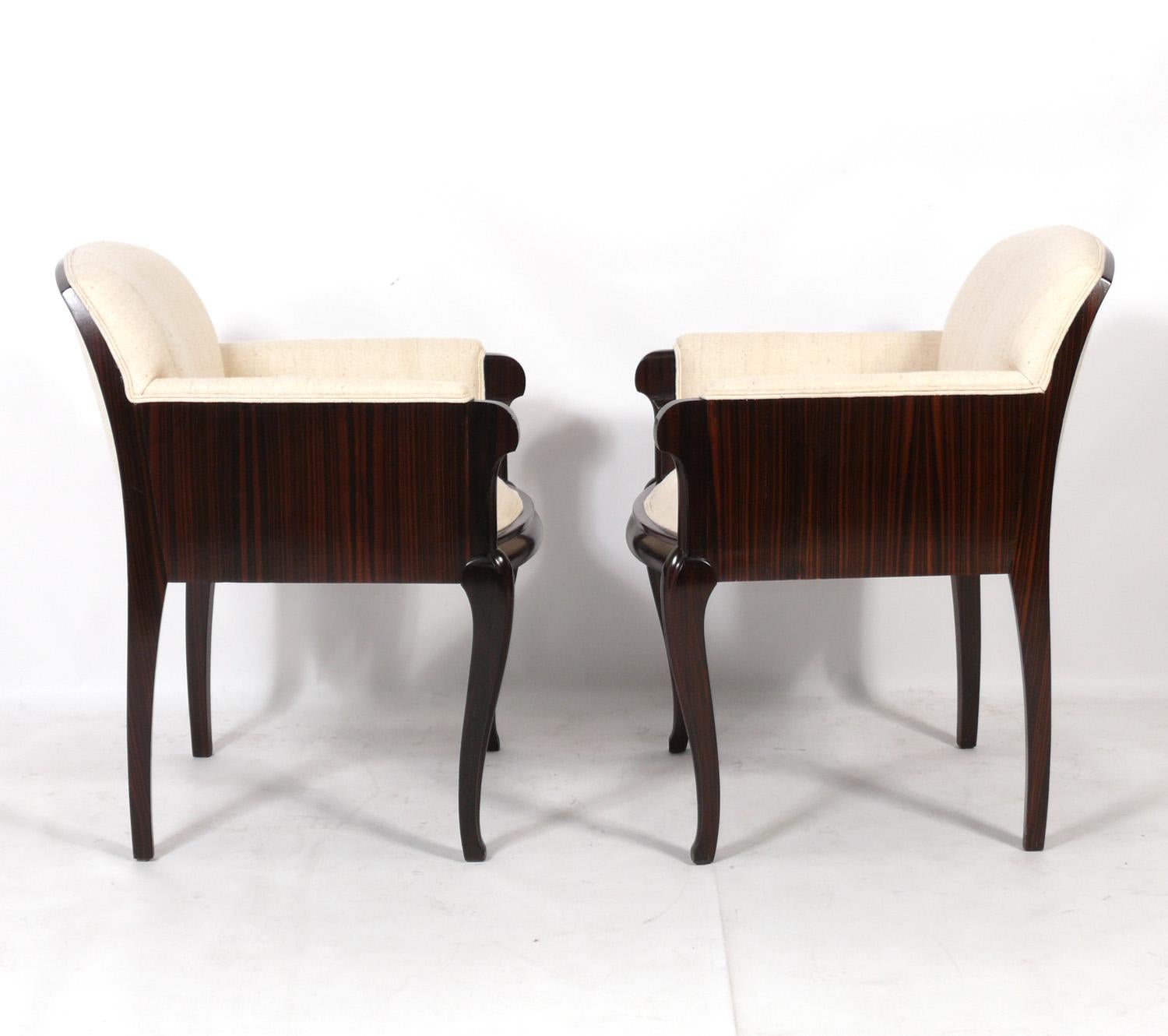 French Art Deco Rosewood and Silk Lounge Chairs, in the manner of Emile Jacques Ruhlmann, France, circa 1930s. They have been completely restored with a new lacquer finish and new raw silk upholstery. They are a versatile size and can be used as