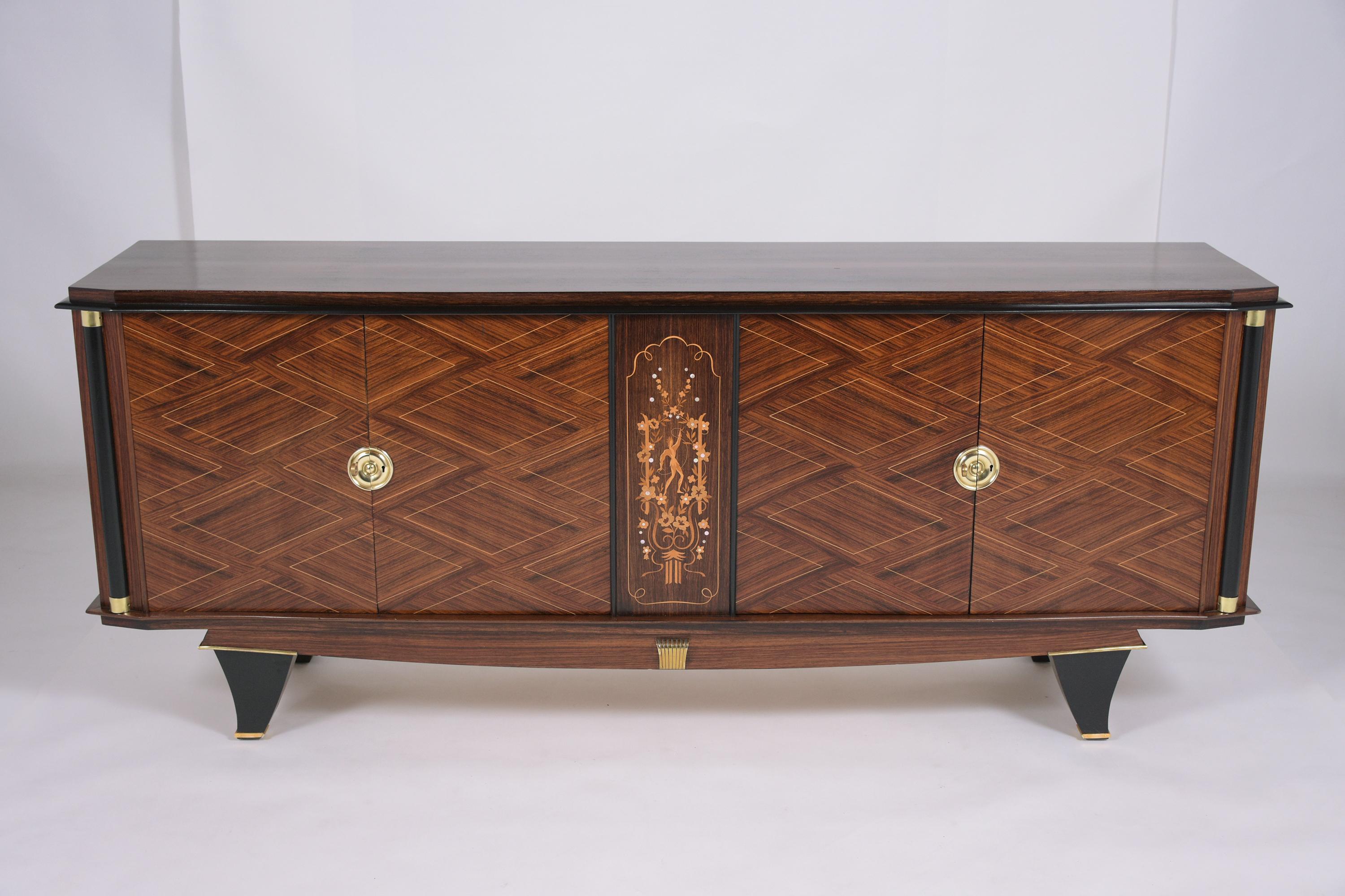 An extraordinary french art deco rosewood buffet beautifully crafted out of rosewood and has been professionally restored by our craftsmen team. This elegant sideboard features eye-catching mahogany and ebonized color combination with lacquered