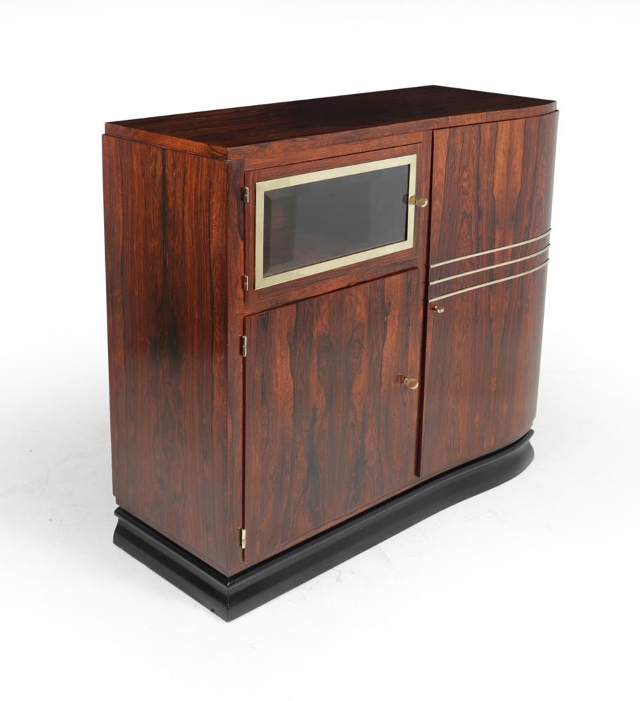 A French art deco cabinet in rosewood with polished brass detail, working locks with three keys supplied. The cabinet has three doors one of these has bevelled glass with brass surround. 

 