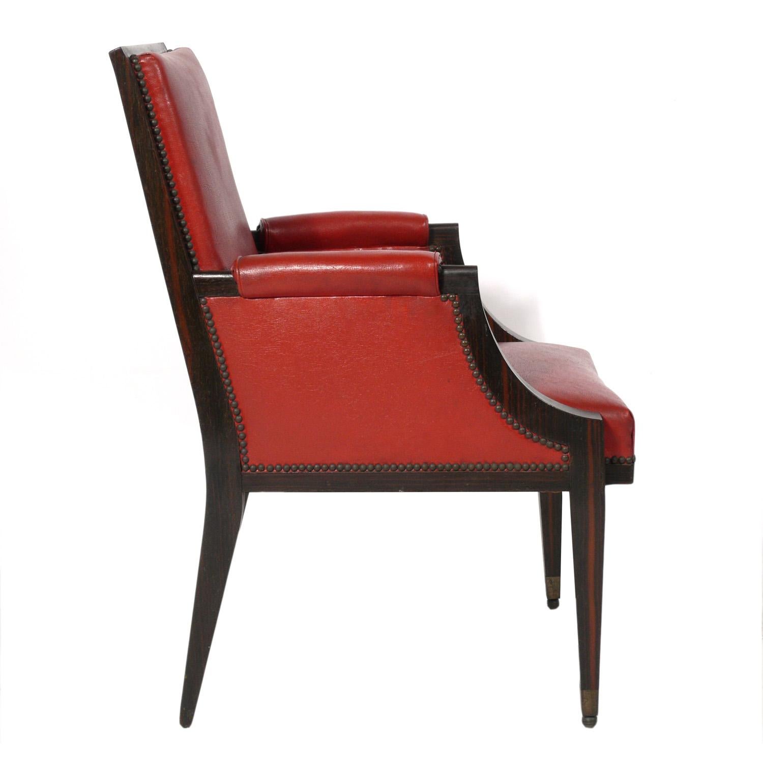 French Art Deco rosewood armchair, France, circa 1930s. It is a versatile size and can be used a lounge chair, desk chair, or occasional chair. It retains it's original burnt orange-red color leatherette upholstery.