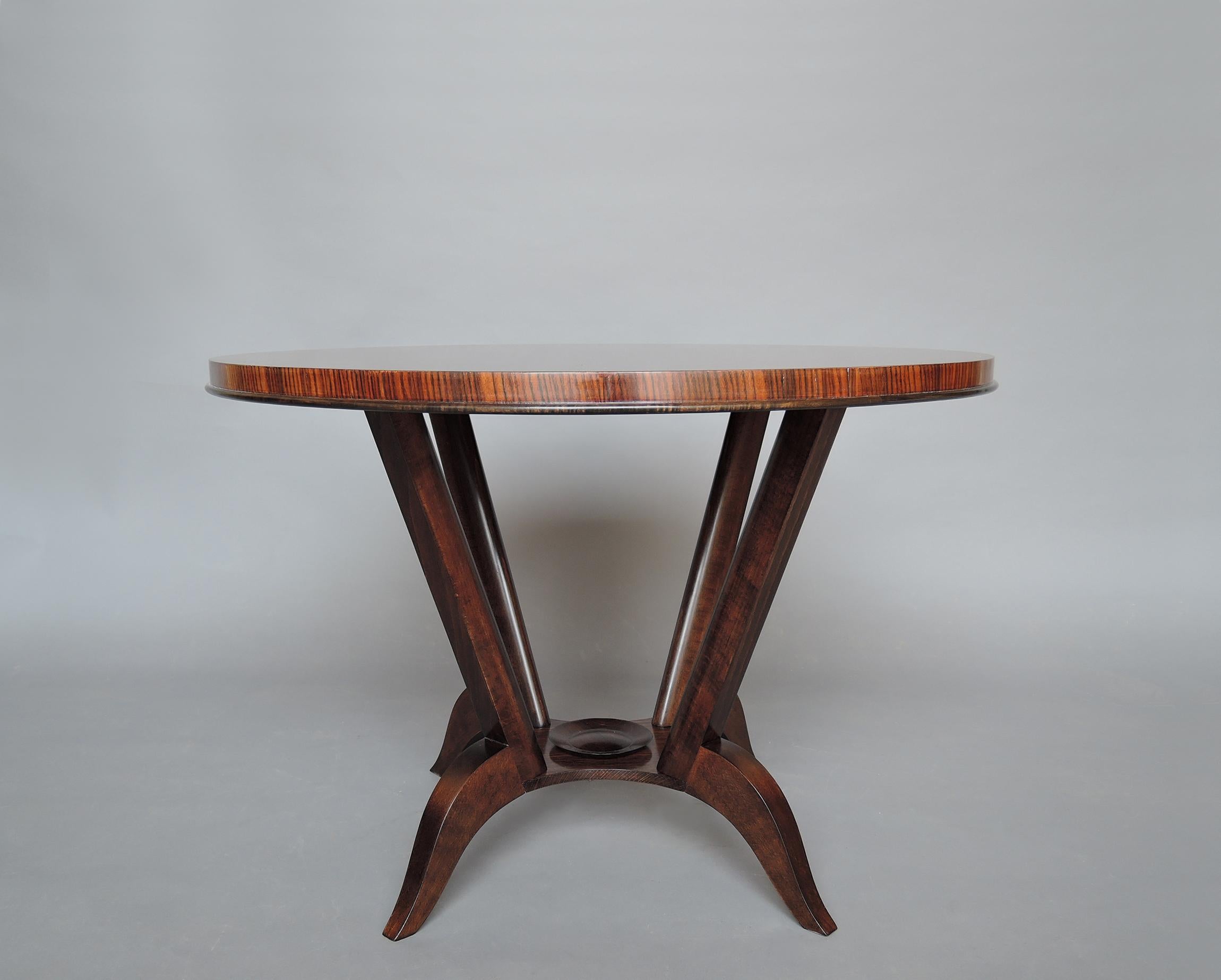 A fine French Art Deco gueridon / side table with a rosewood top and a four curved-leg ebonized pedestal.