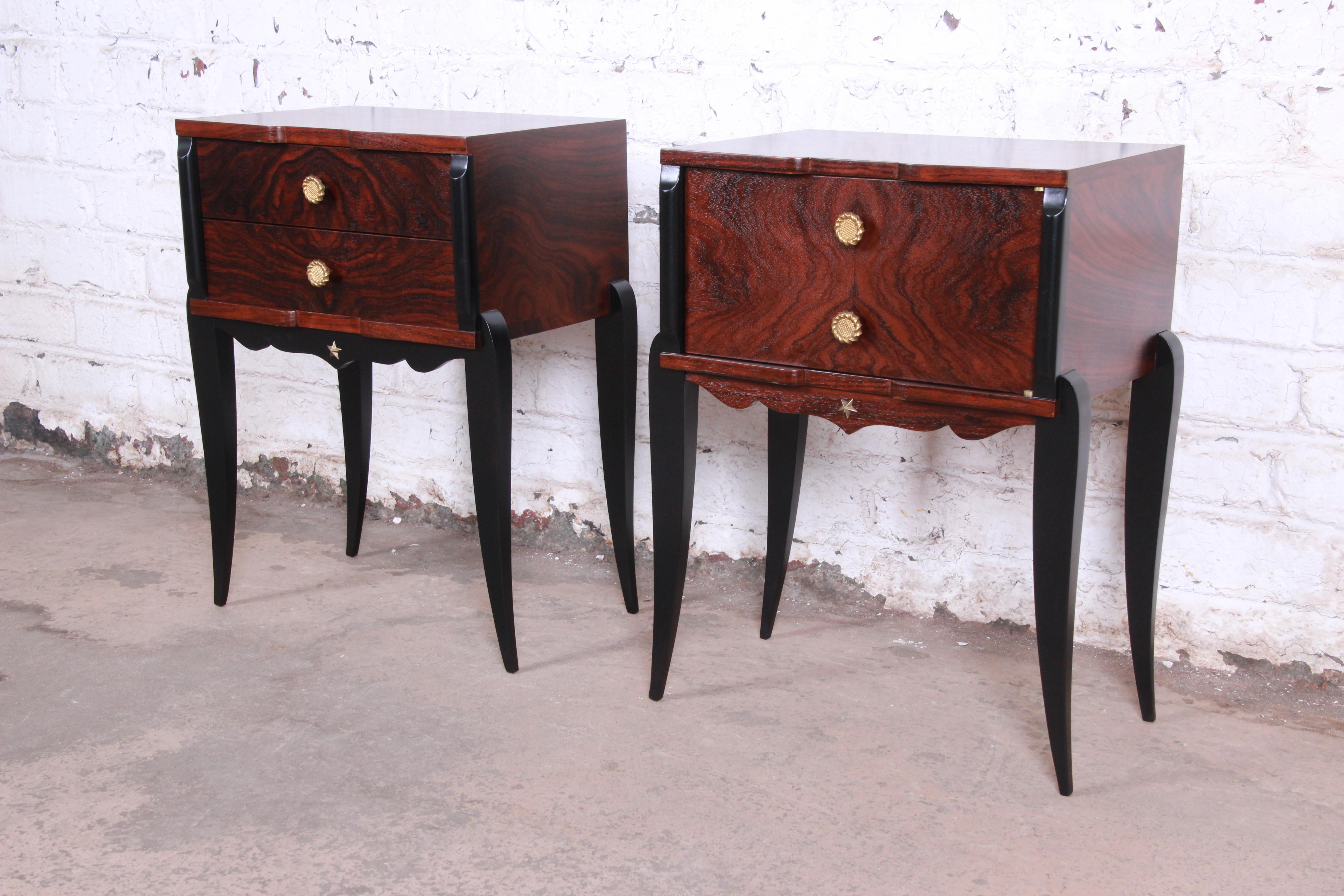 An exceptional pair of French Art Deco nightstands, circa 1930s. The nightstands feature gorgeous rosewood grain, with ebonized trim and tall, elegantly curved ebonized legs. They offer good storage, one with two dovetailed drawers and the other