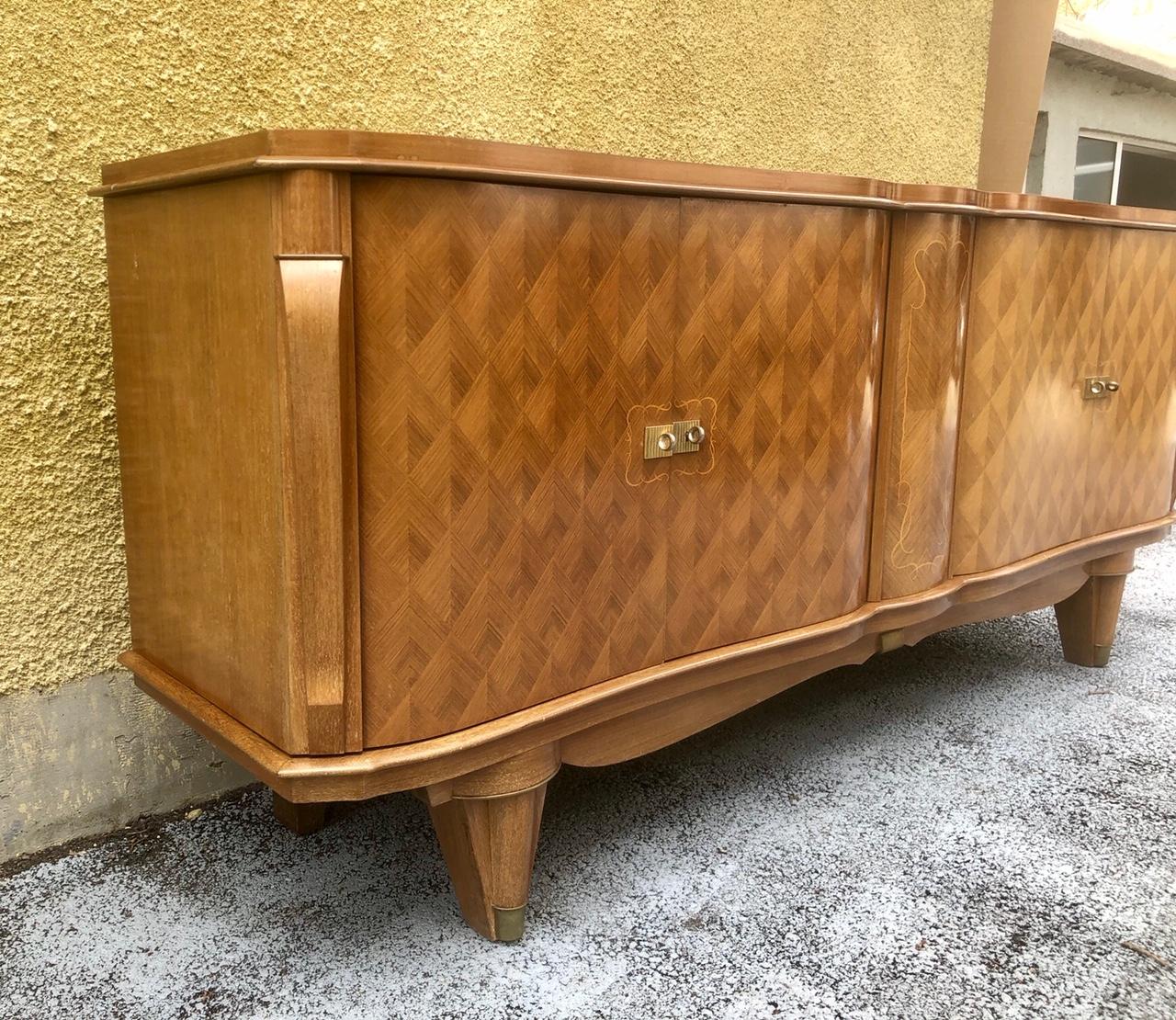 This sideboard was made in France in the 1940s in the famous furniture house of Art Deco designer - Jules Leleu. The decorative elements on the doors are executed in the typical diamond marquetry manner. The buffet has not been restored due to the