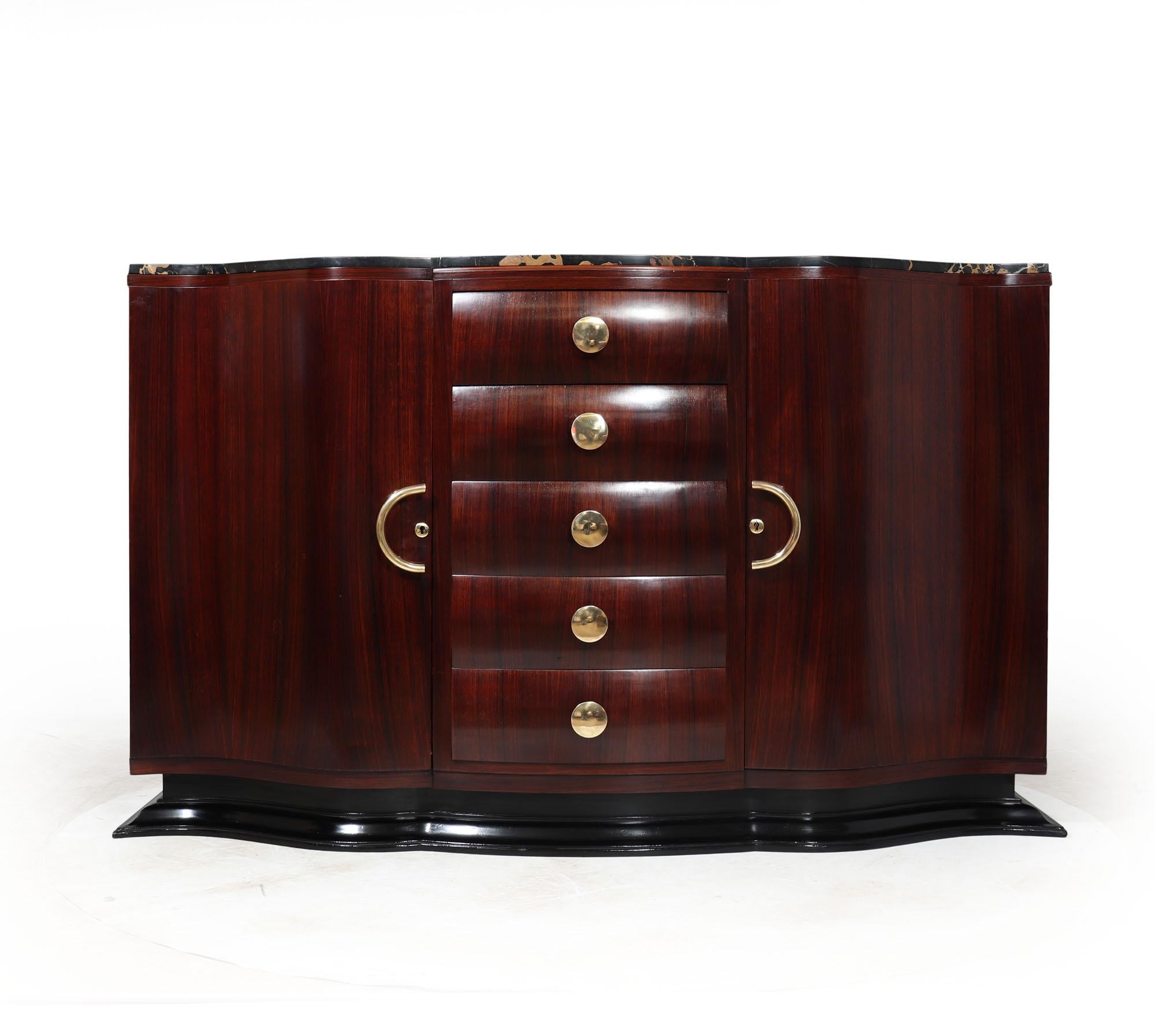 FRENCH ART DECO SIDEBOARD
A stunning serpentine shaped Art Deco sideboard having a Nero Portoro marble top , with five central drawers flanked by two lockable cupboards with fixed shelves behind, solid brass handles and standing on an ebonised