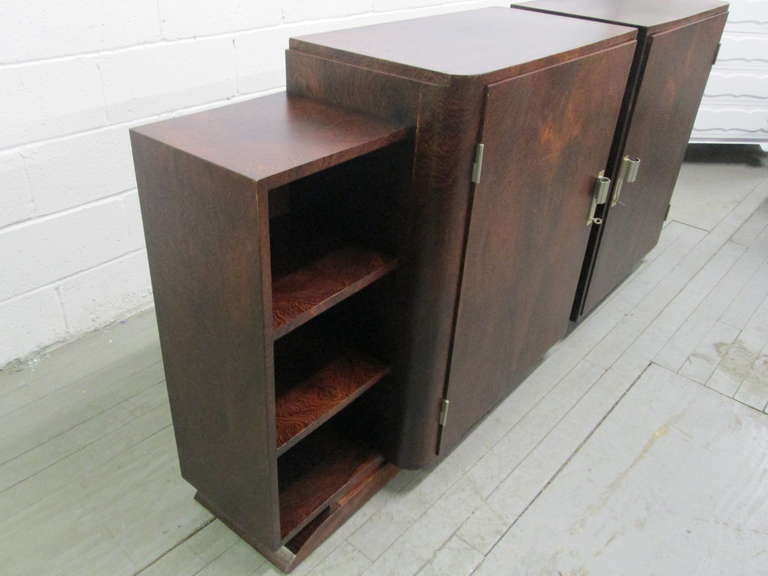 Art Deco sideboard or bookcase on plinth base with shelving. Inside shelves are adjustable. Has brass and nickel handles. 

Each measures: 39