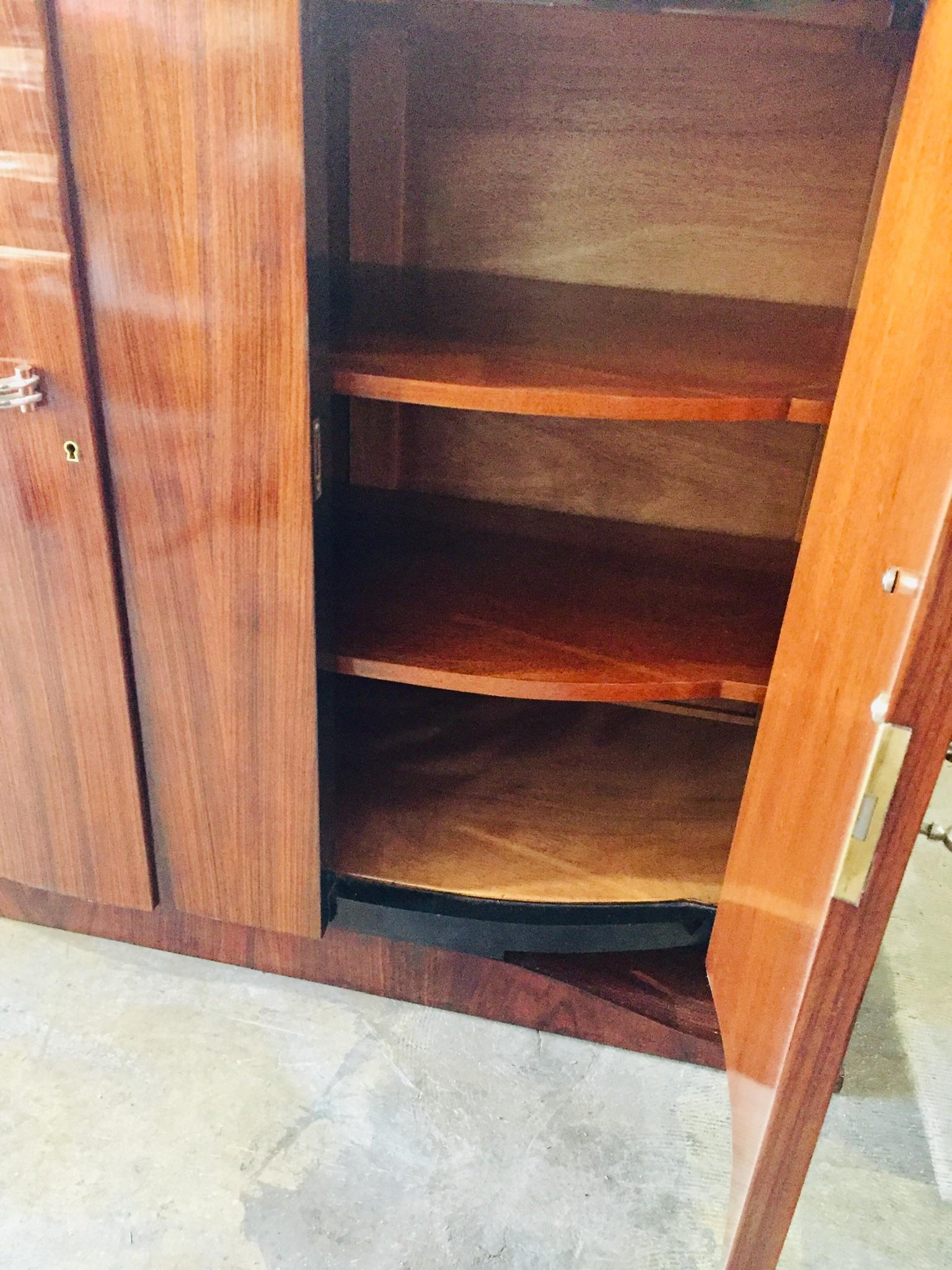 Refined piece of furniture in rosewood veneer inlayed with precious exotic woods and mother of pearl.
Two shelves at each bottom part, one shelf and two drawers in the middle.
recently refinished. All parts and hardware’s from origine.
 