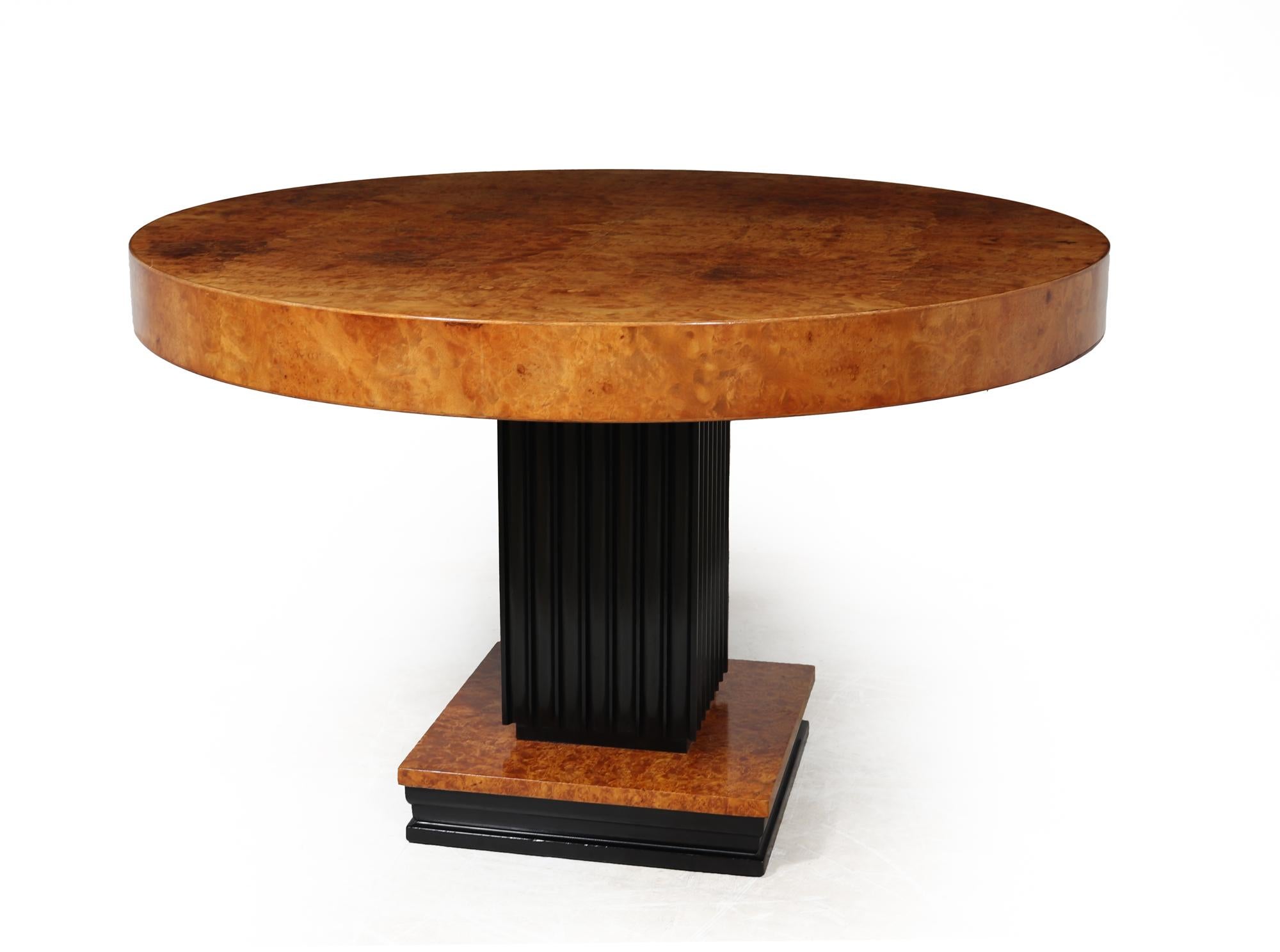 ART DECO DINING TABLE 
This exquisite Art Deco dining table is a true masterpiece, showcasing the beauty of burr maple veneers in all its glory. The ebonised upright and square base add a touch of sophistication and elegance to the overall design,